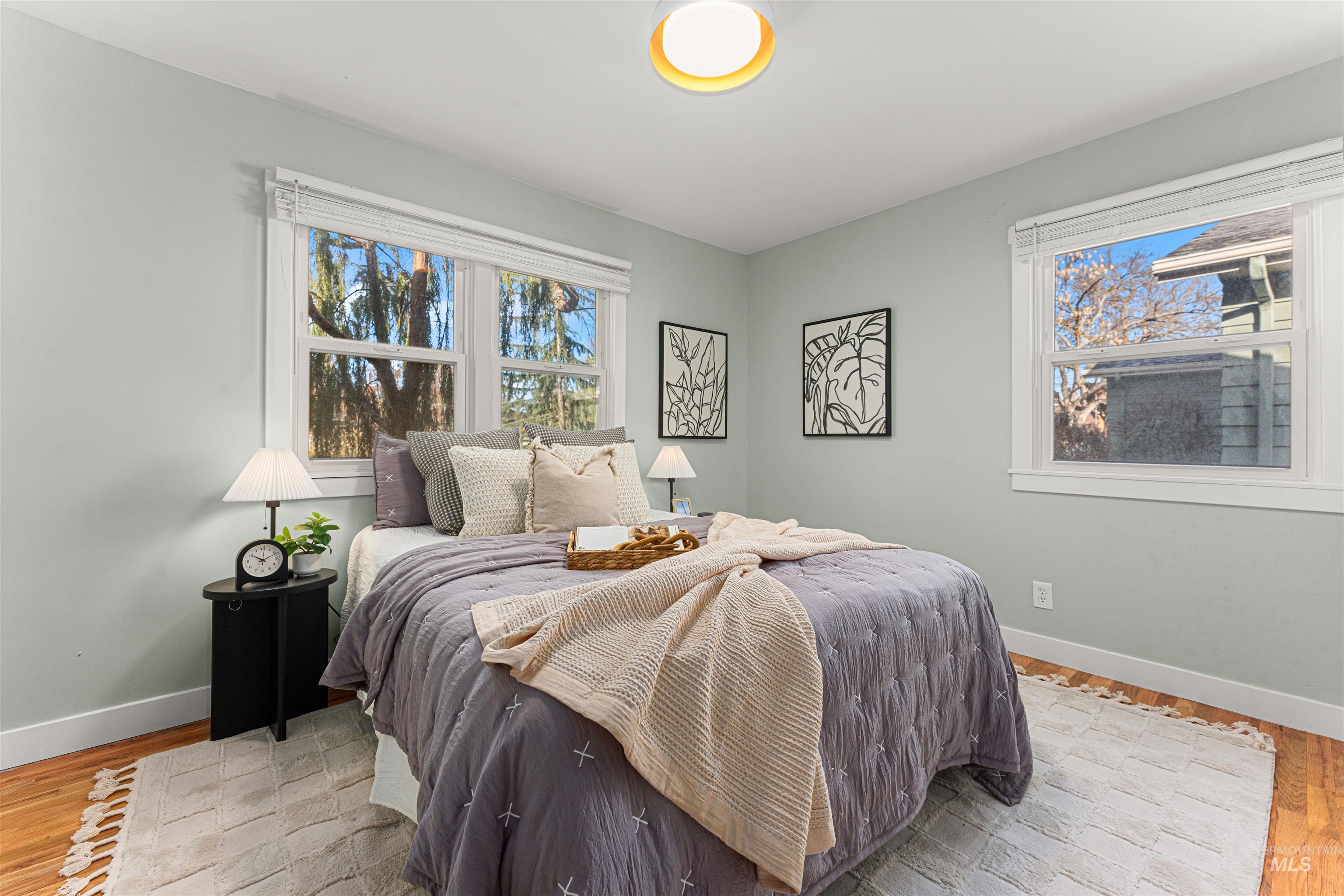 Bungalow-style house with a chimney, a shingled roof, and a front lawn