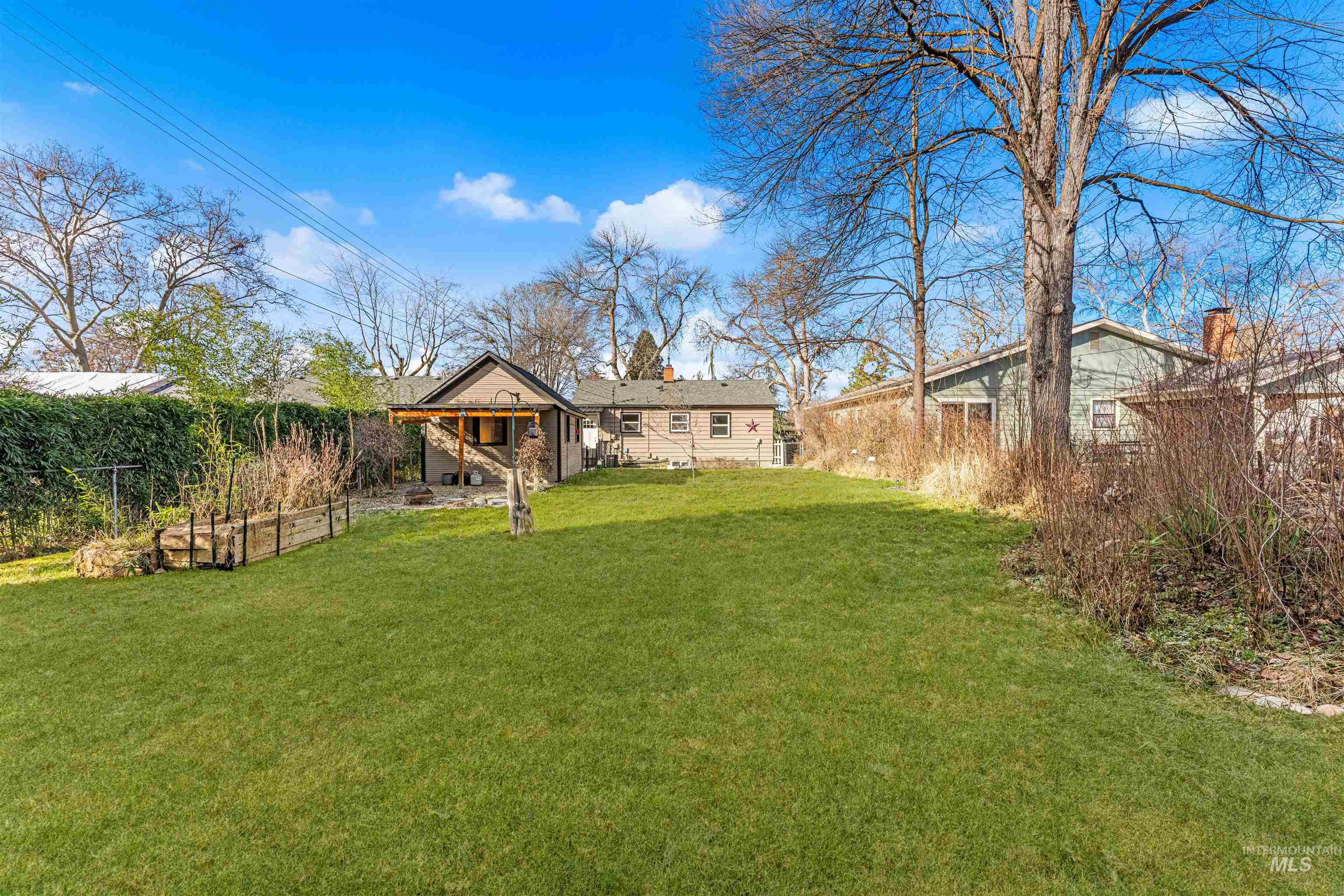 Fenced backyard featuring a vegetable garden