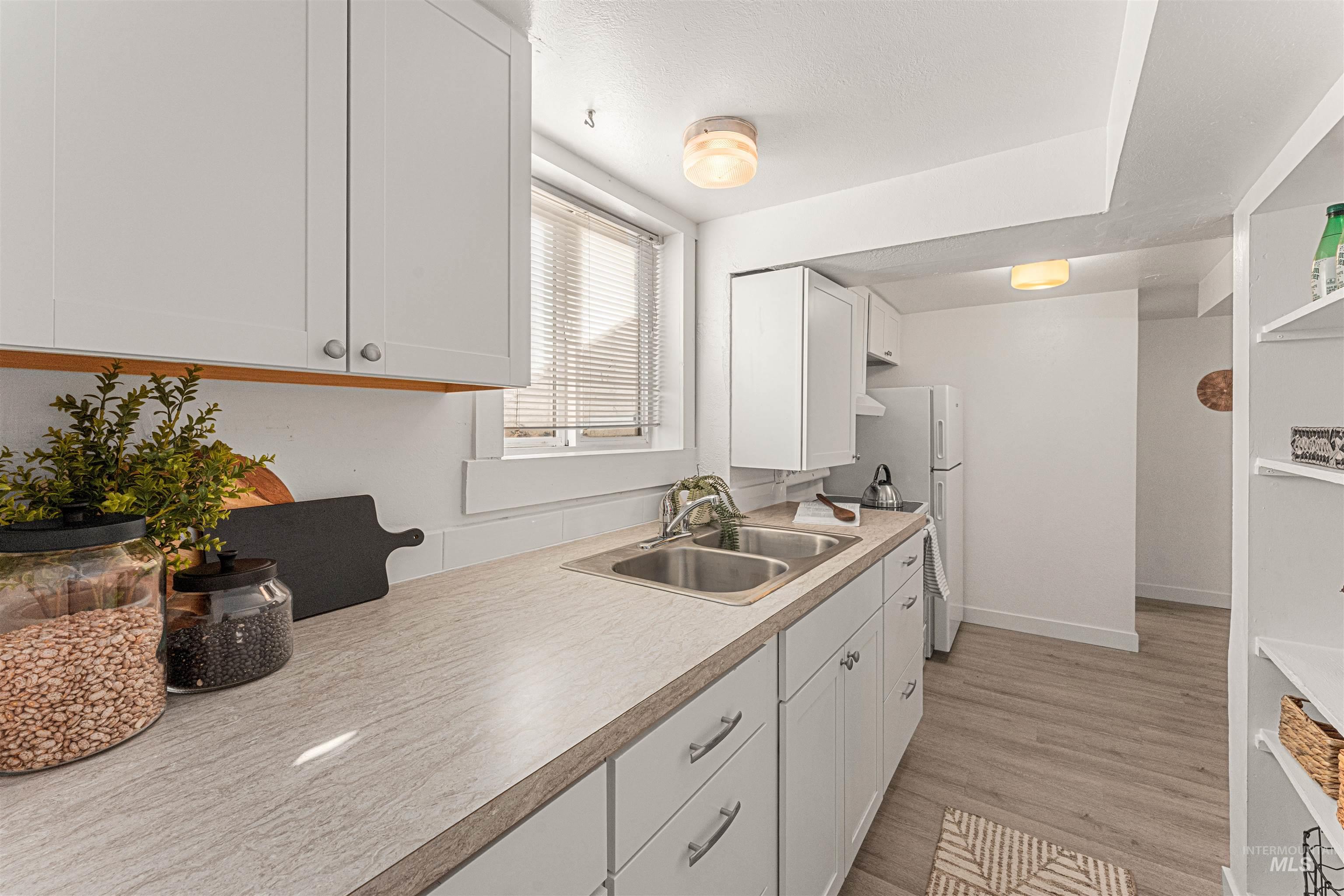 Dining area with baseboards and light wood finished floors