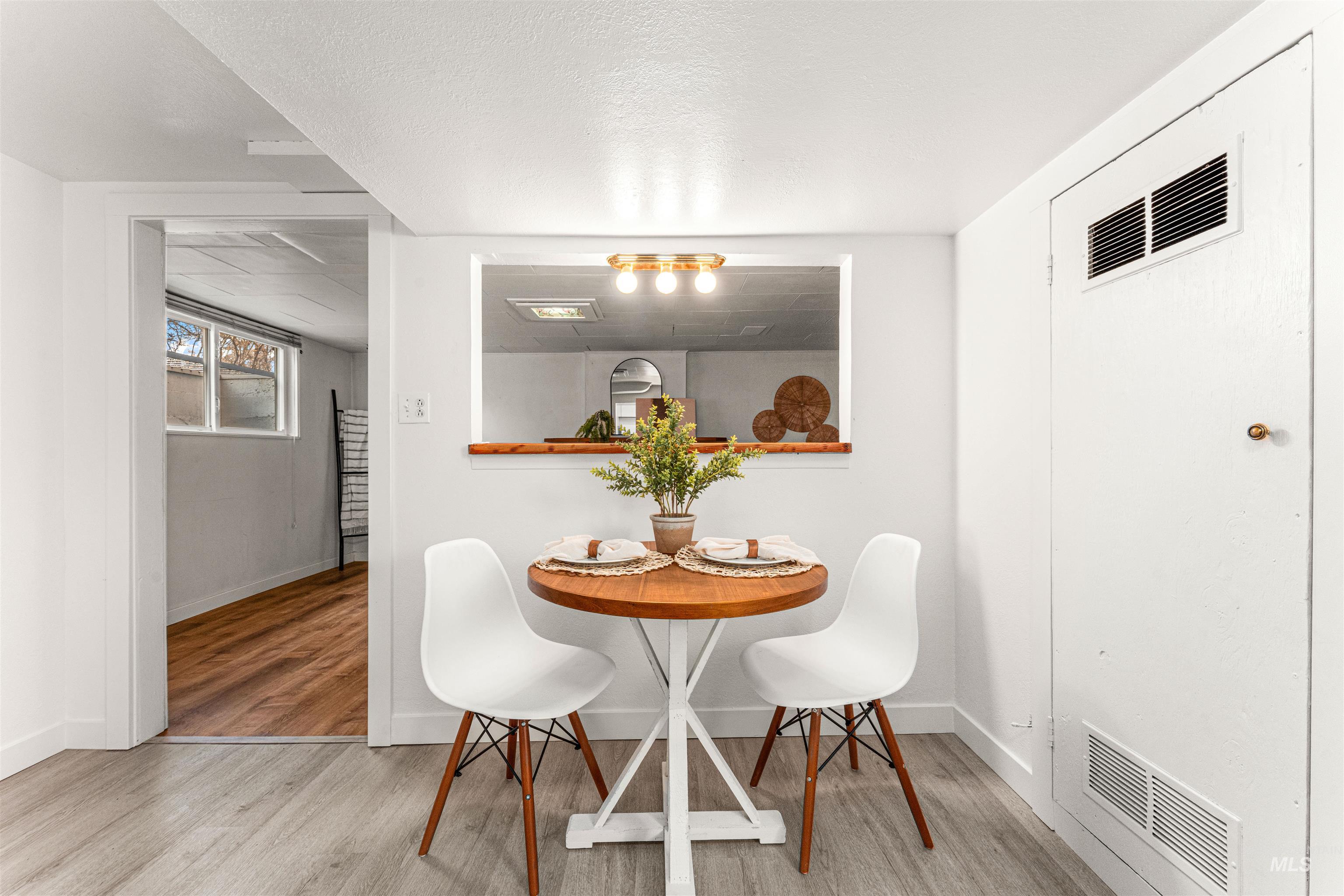 Unfurnished room with dark wood-style floors, wood walls, and a textured ceiling