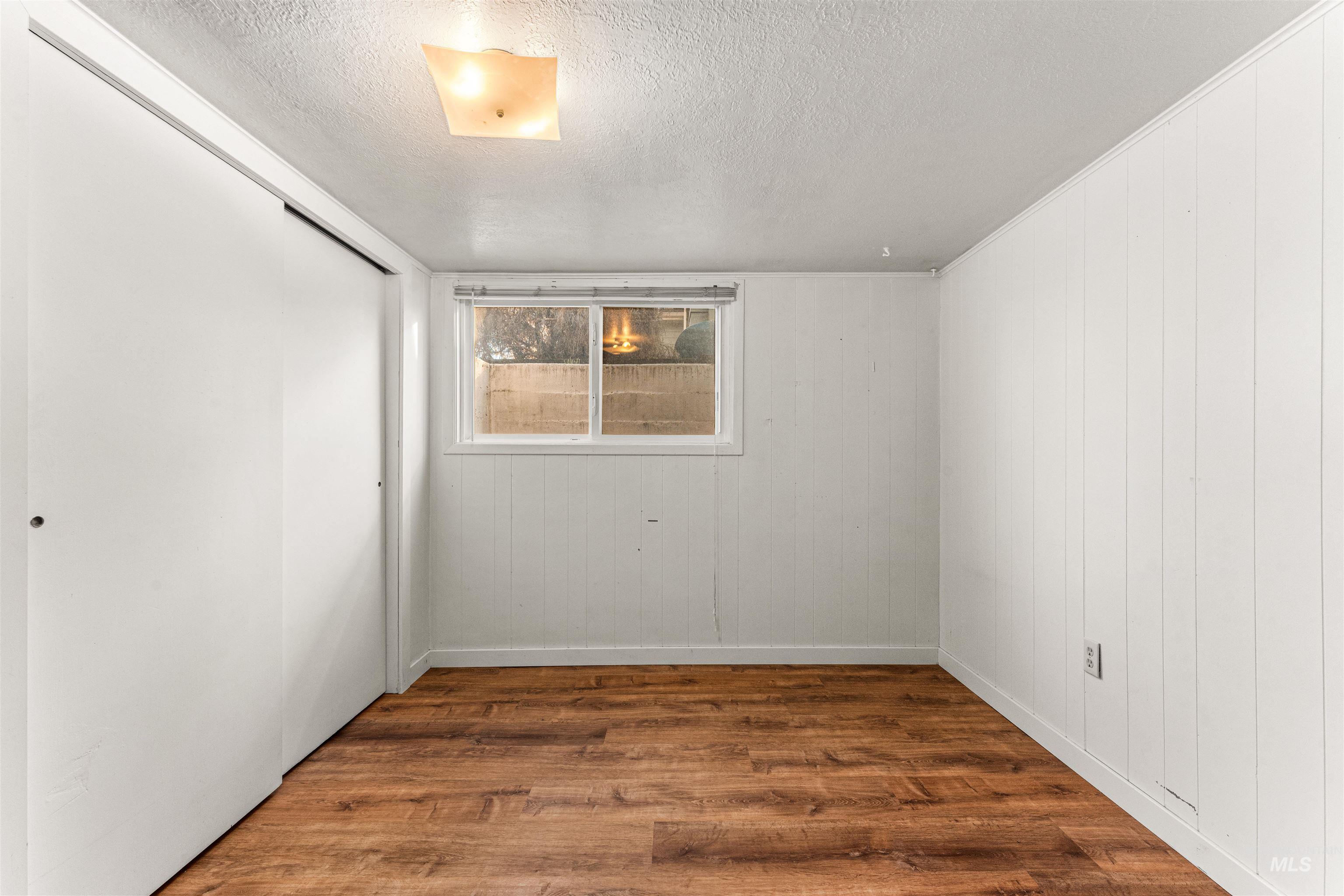 Living room with light wood-type flooring and built in features