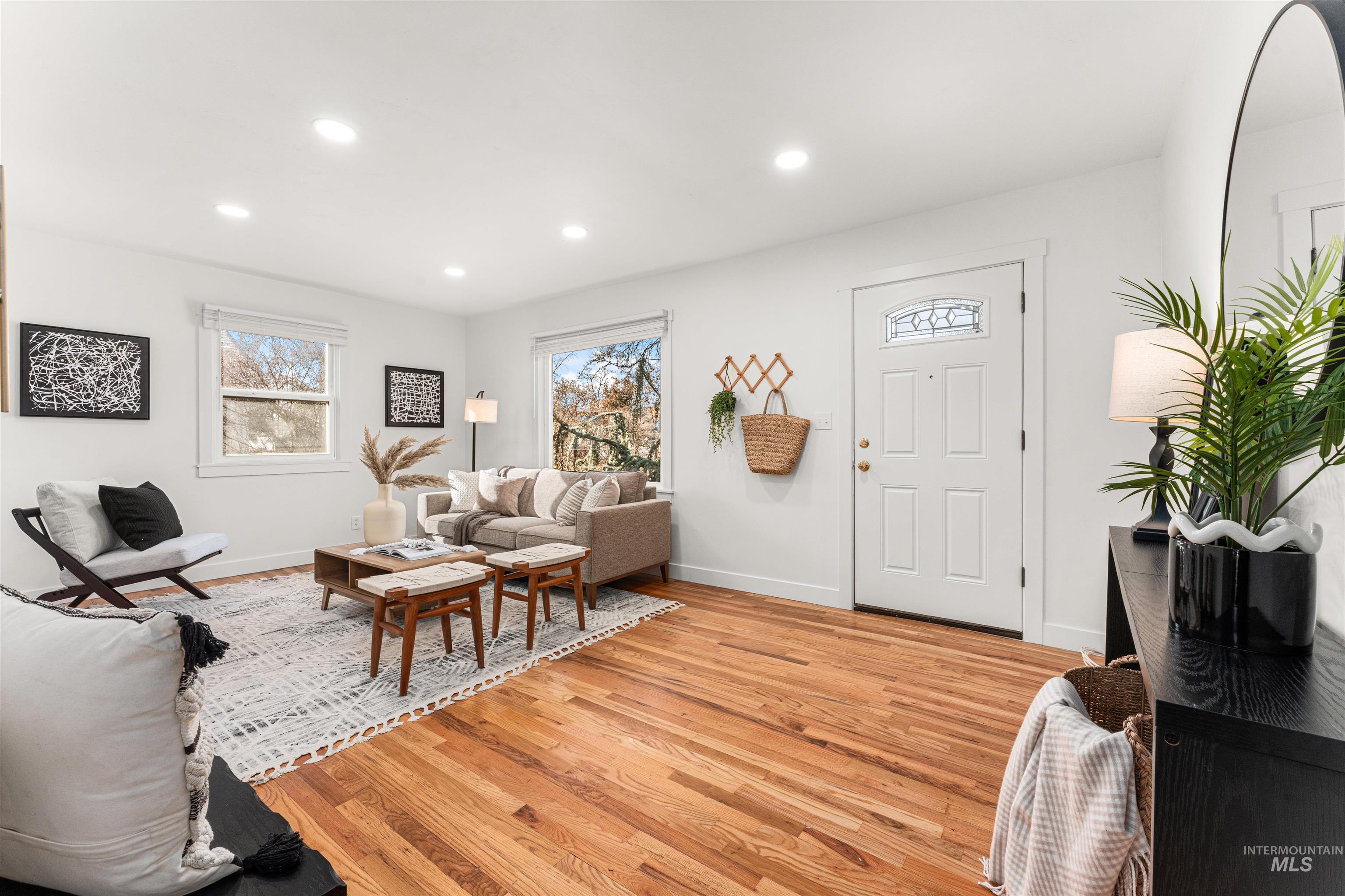 Living area with light wood-style flooring and recessed lighting
