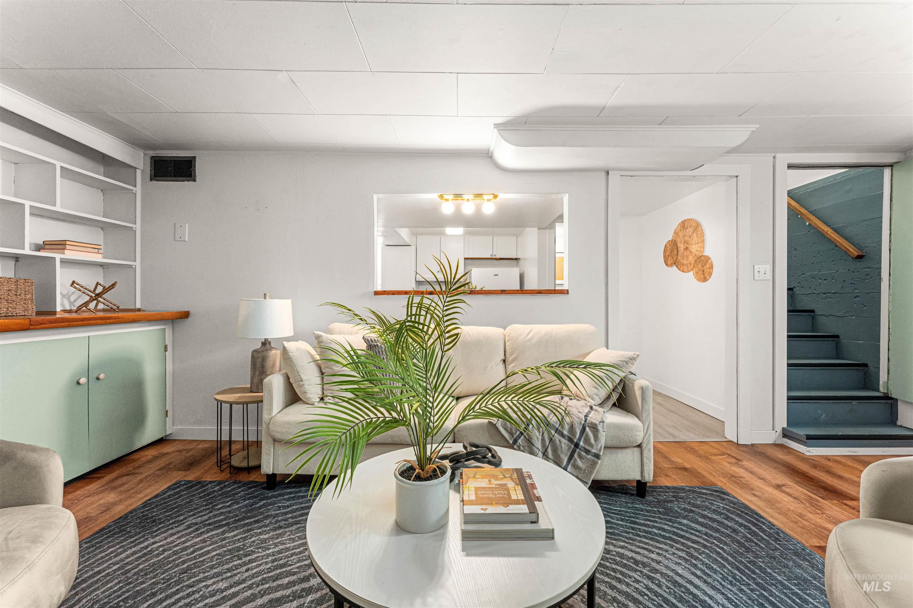 Living area with wood finished floors and baseboards
