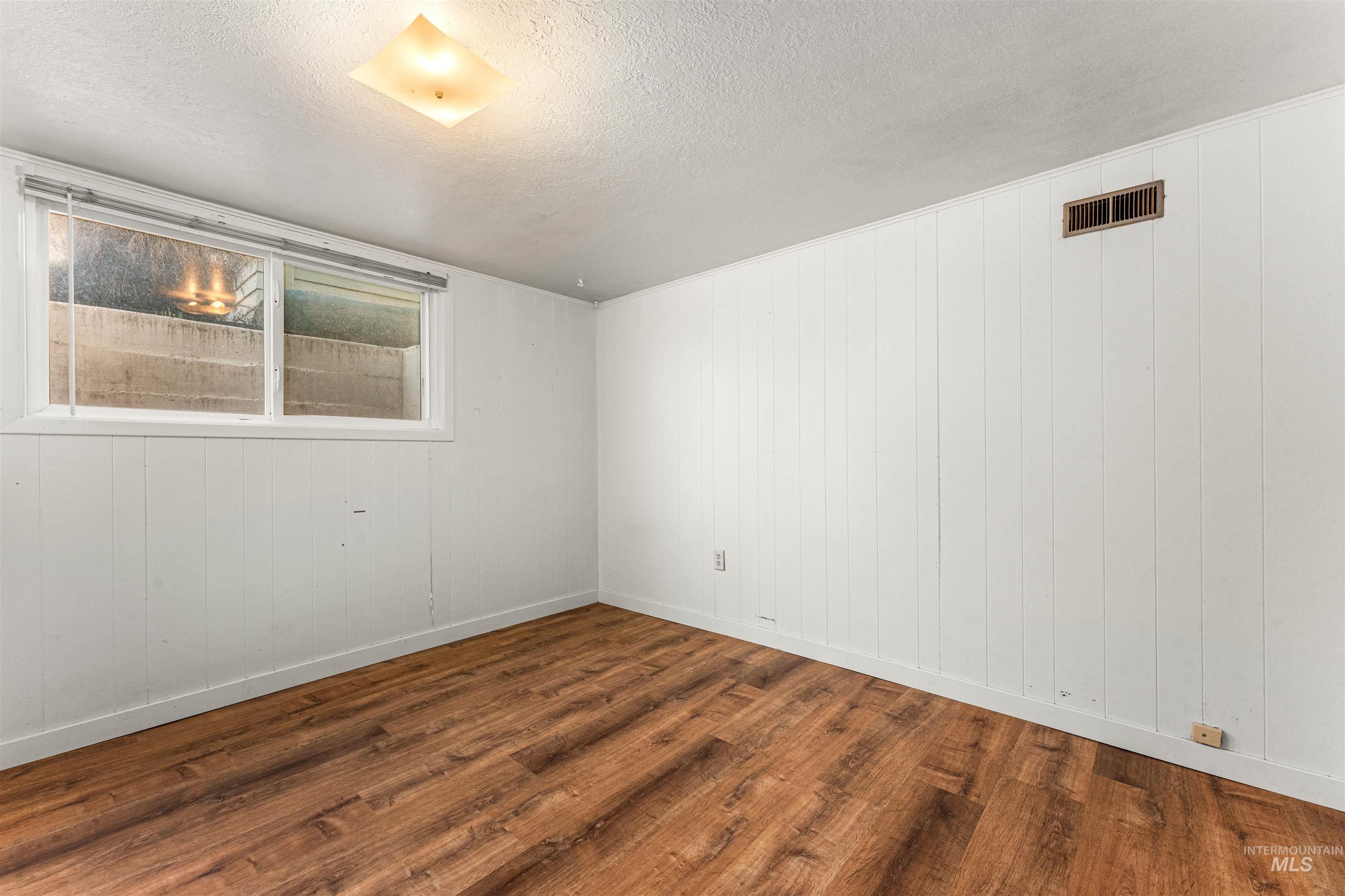 Living room featuring wood finished floors and built in features