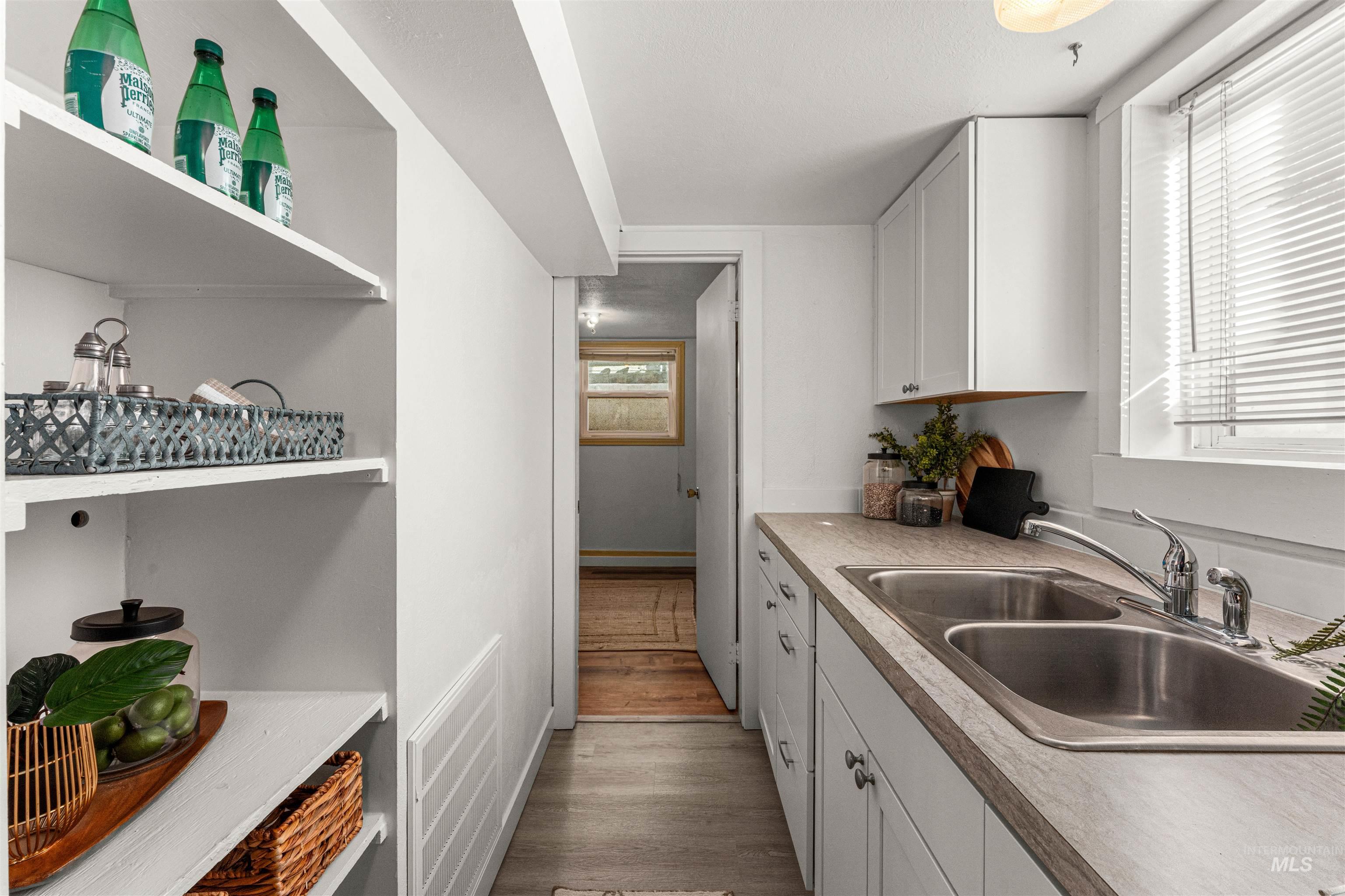 Dining area featuring light wood-style floors and baseboards