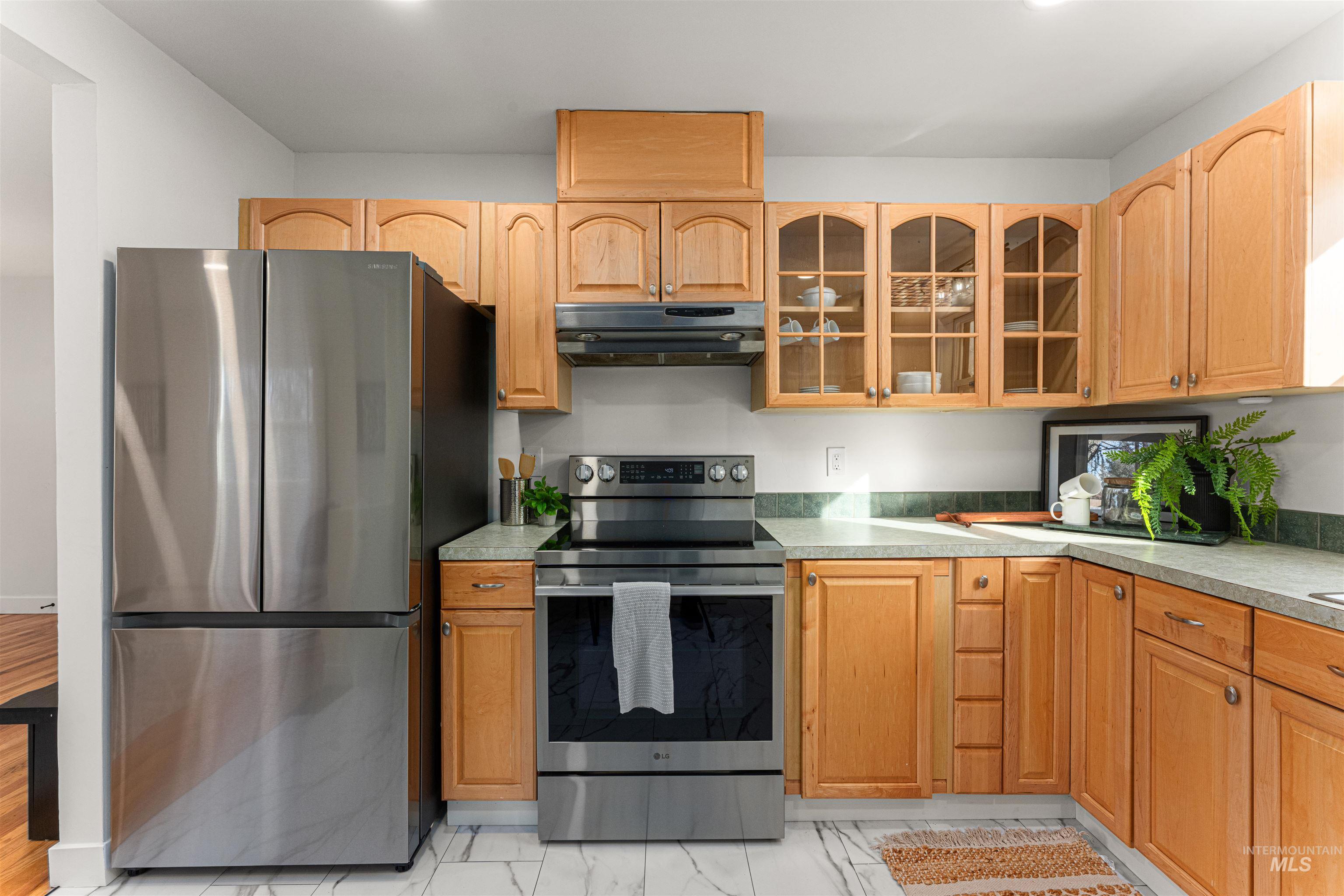 Bungalow-style house with a chimney, a shingled roof, and a front lawn