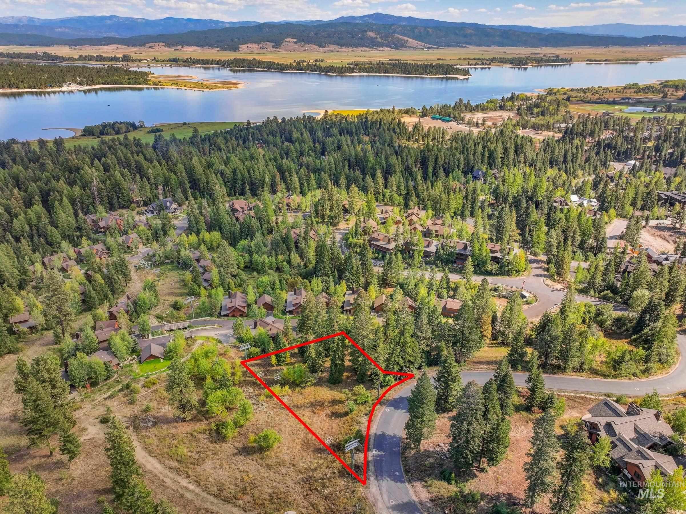 Aerial view of property's location with property boundaries highlighted and a water and mountain view