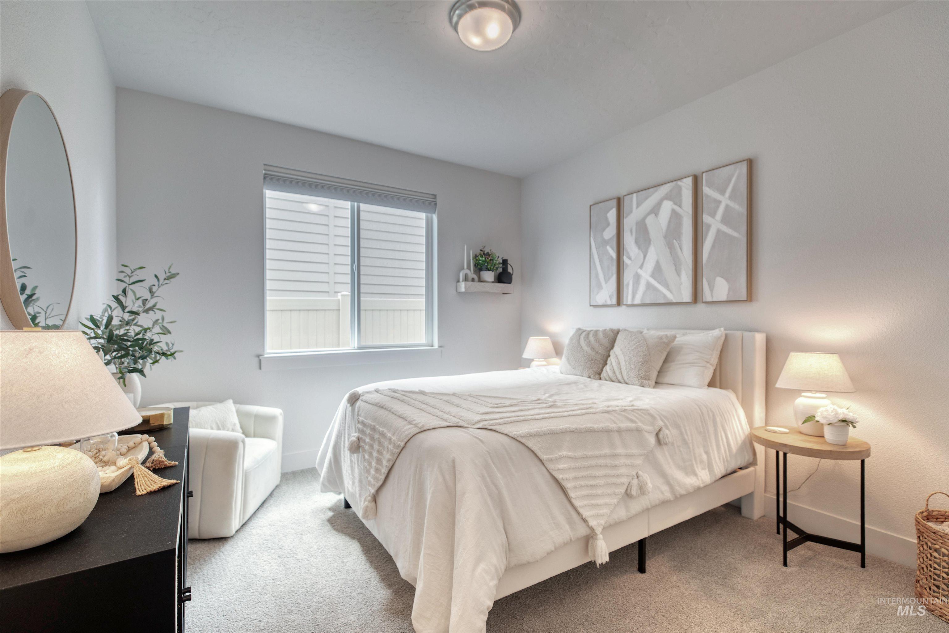 Bedroom with light carpet and baseboards