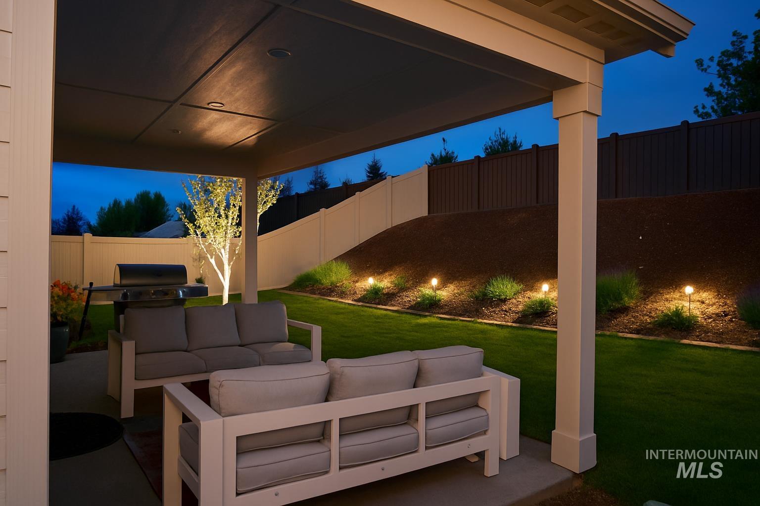 Patio at twilight featuring a patio, an outdoor hangout area, a fenced backyard, and a grill