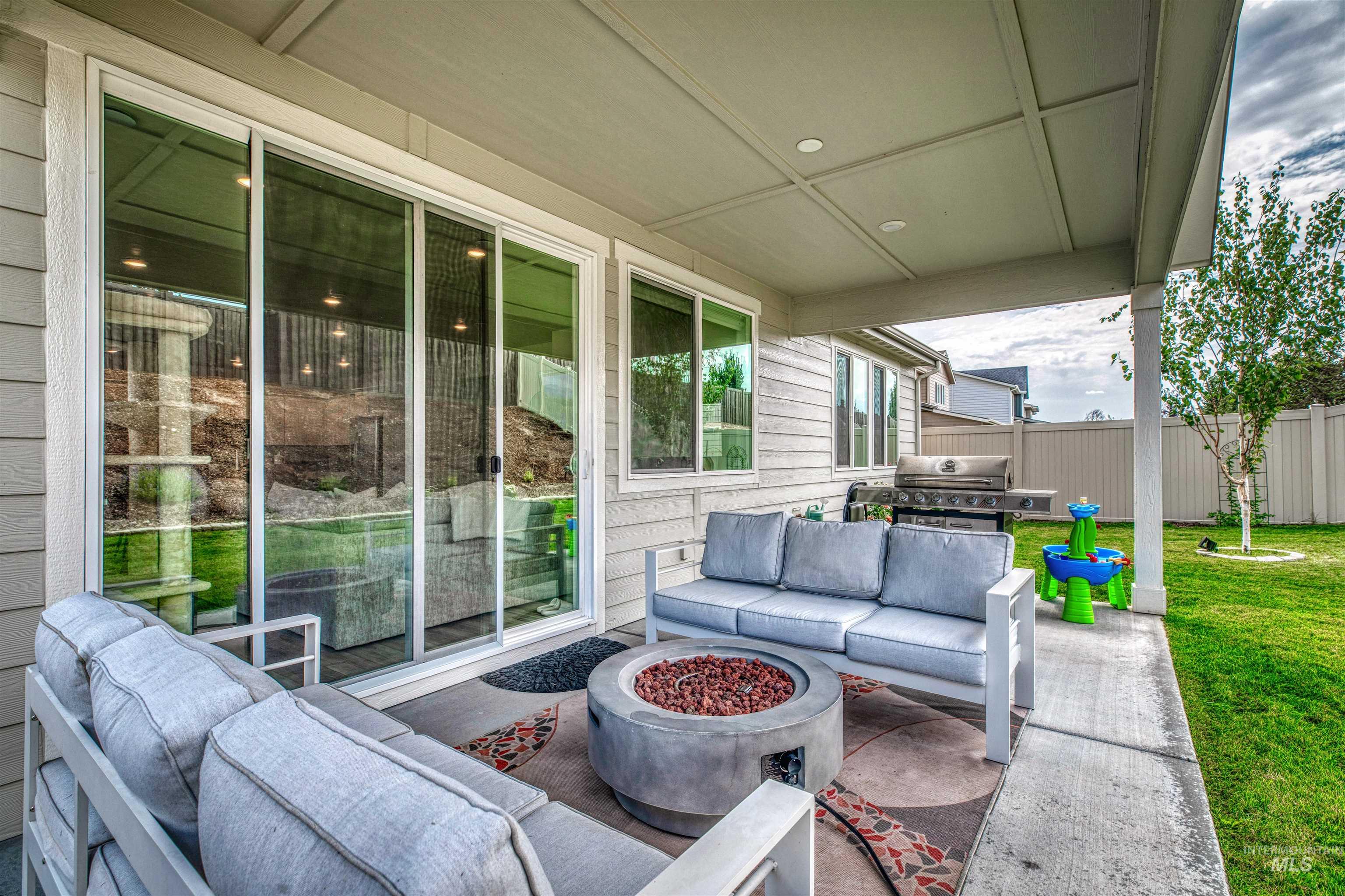 View of patio / terrace featuring an outdoor living space with a fire pit and grilling area
