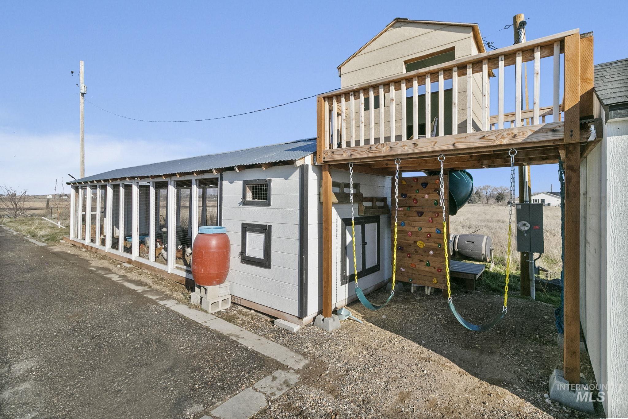 Rear view of property featuring an outdoor structure