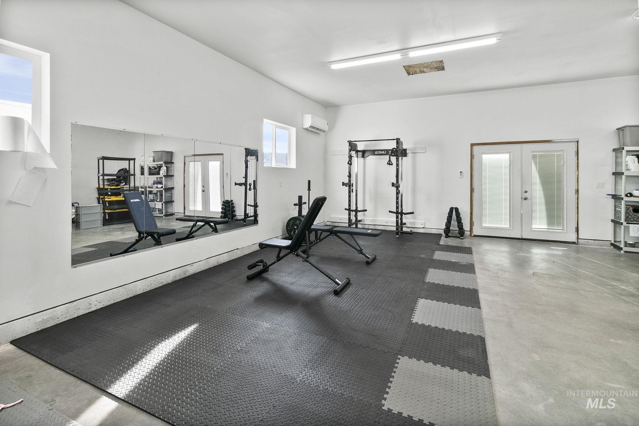 Gym featuring french doors