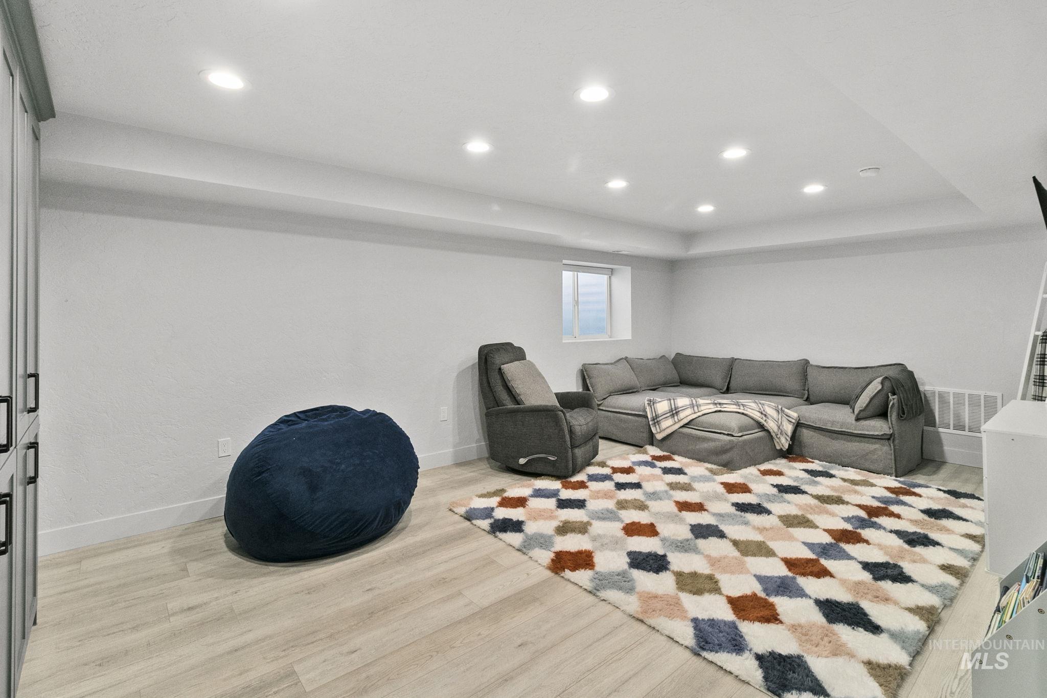 Living room with recessed lighting and light wood finished floors