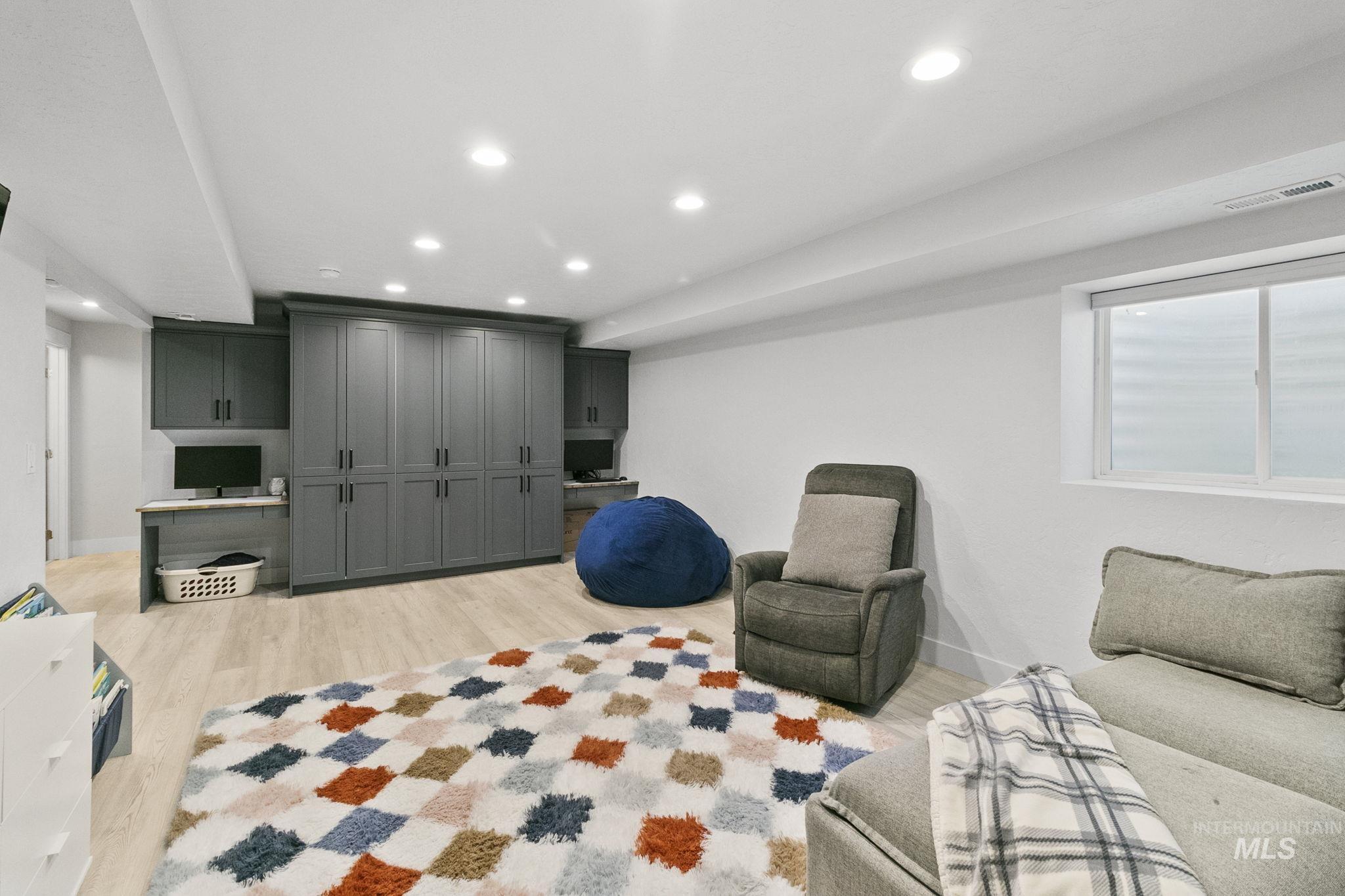 Living area with recessed lighting and light wood-type flooring