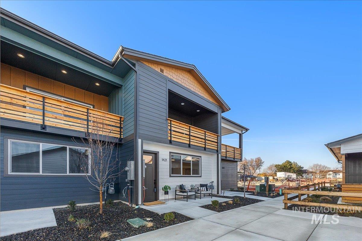Rear view of property with a balcony and a patio area