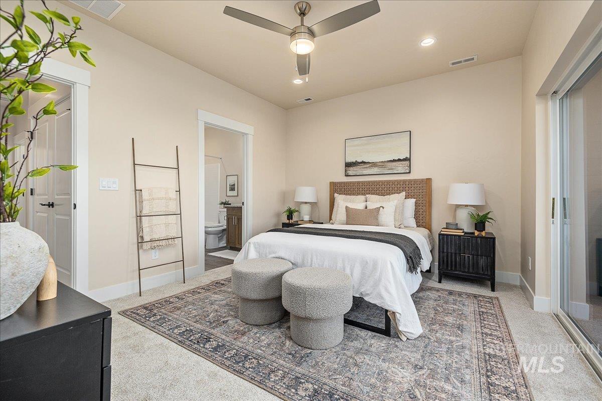 Bedroom with light colored carpet, a ceiling fan, connected bathroom, and recessed lighting