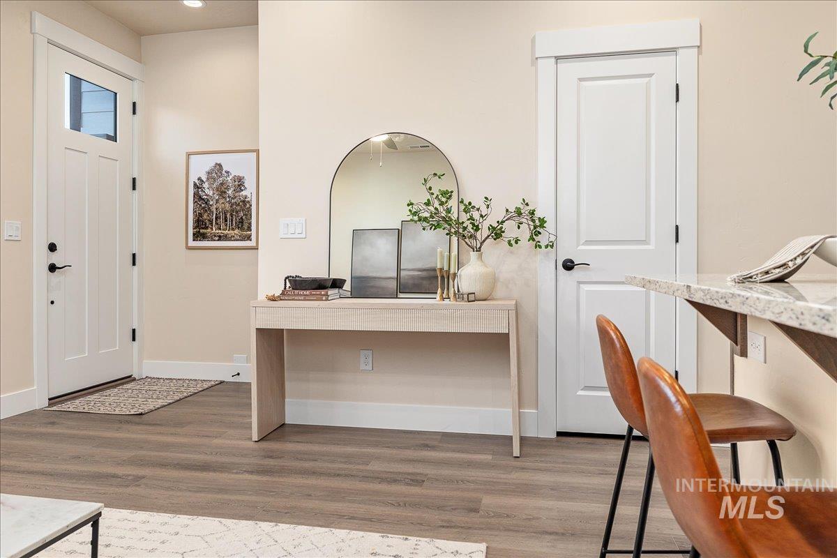 Entrance foyer with wood finished floors and baseboards