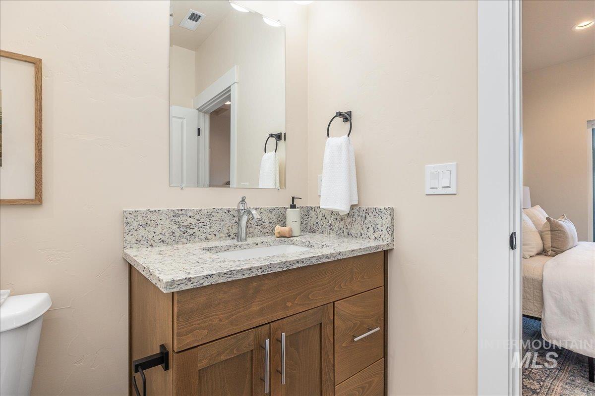 Ensuite bathroom with vanity and toilet