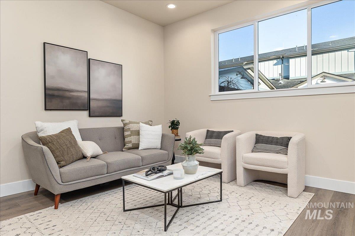 Living room with wood finished floors and recessed lighting
