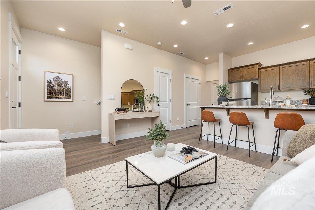 Living room with recessed lighting and light wood finished floors