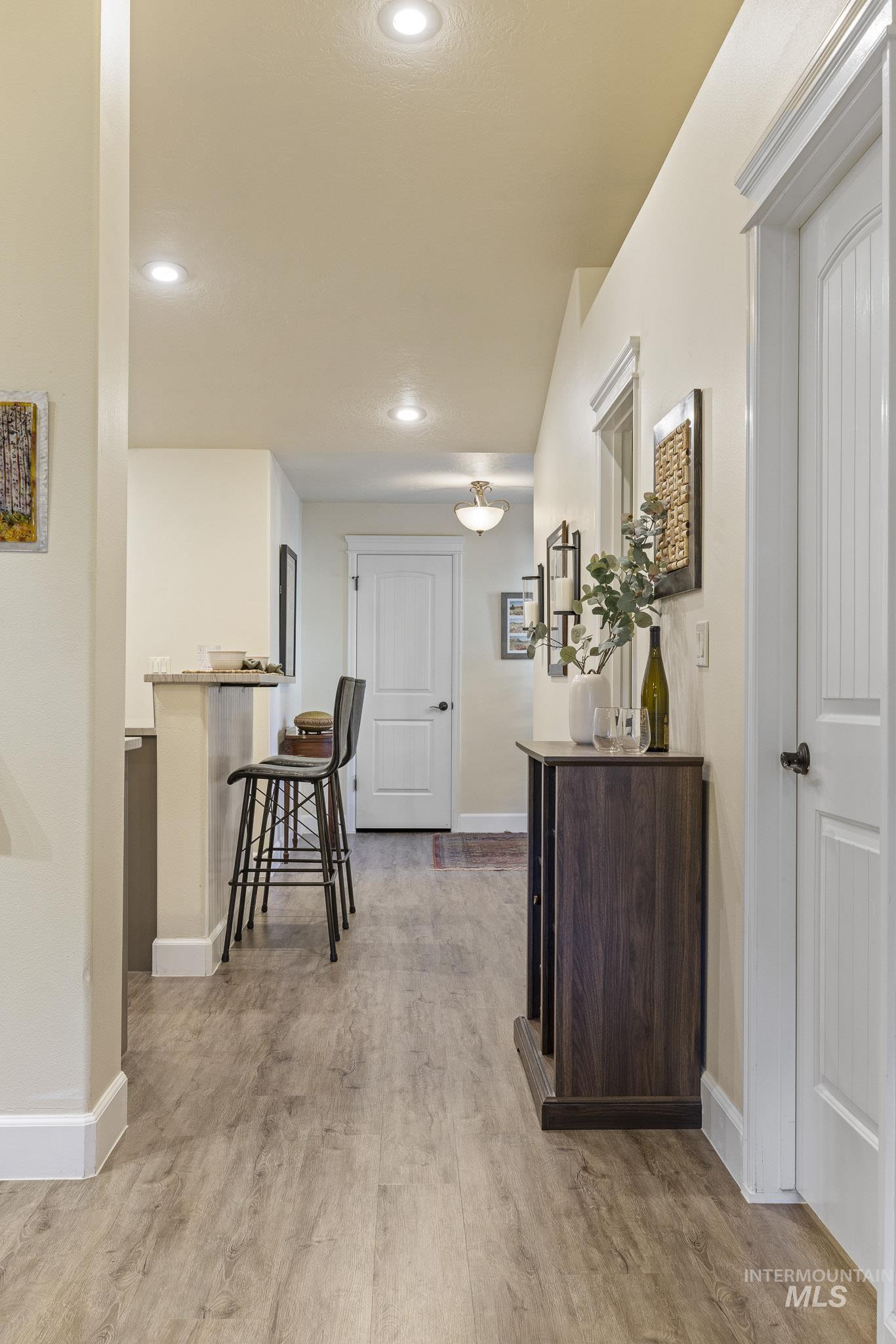 Hall featuring light wood-style floors and recessed lighting