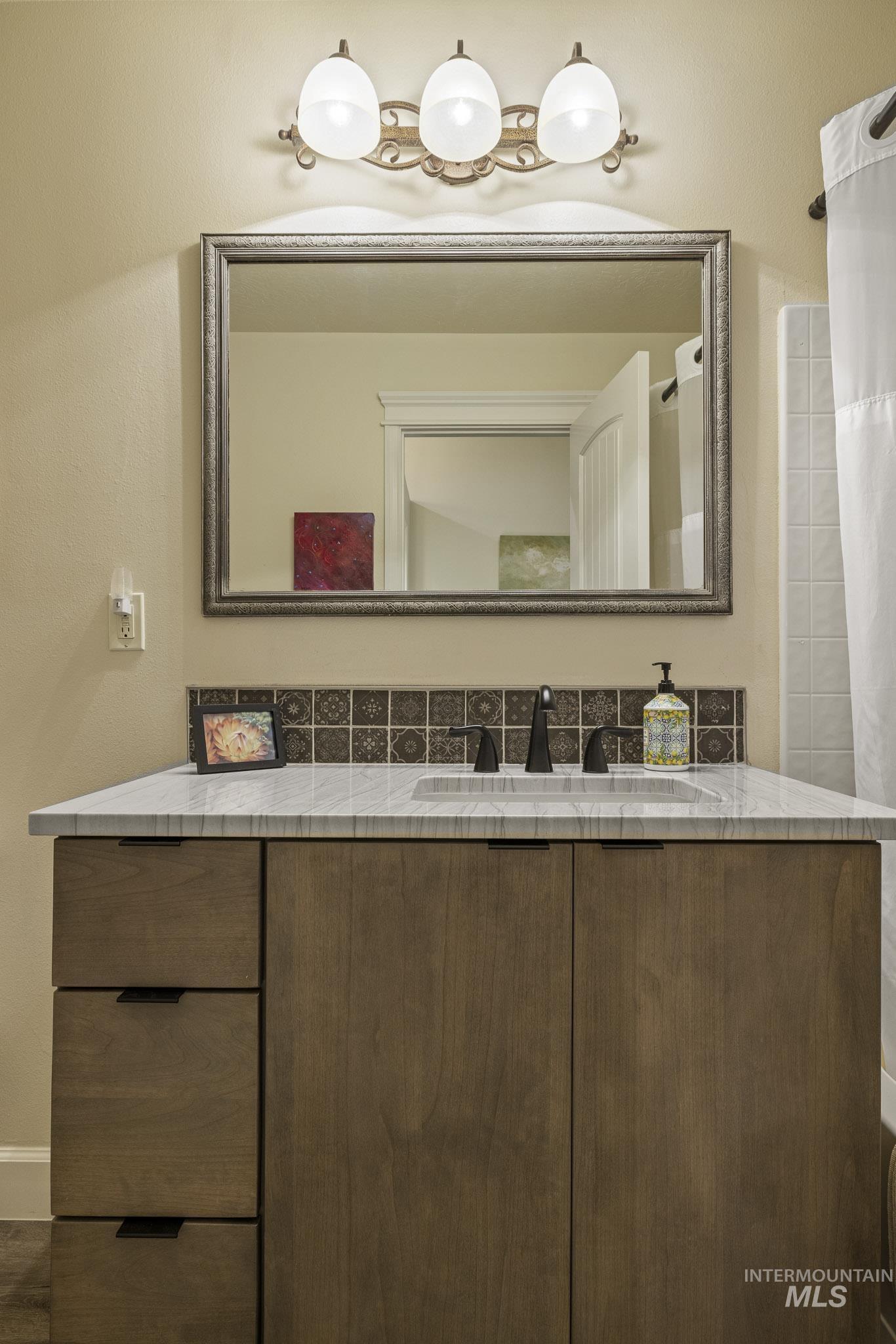 Bathroom with vanity and a shower with curtain