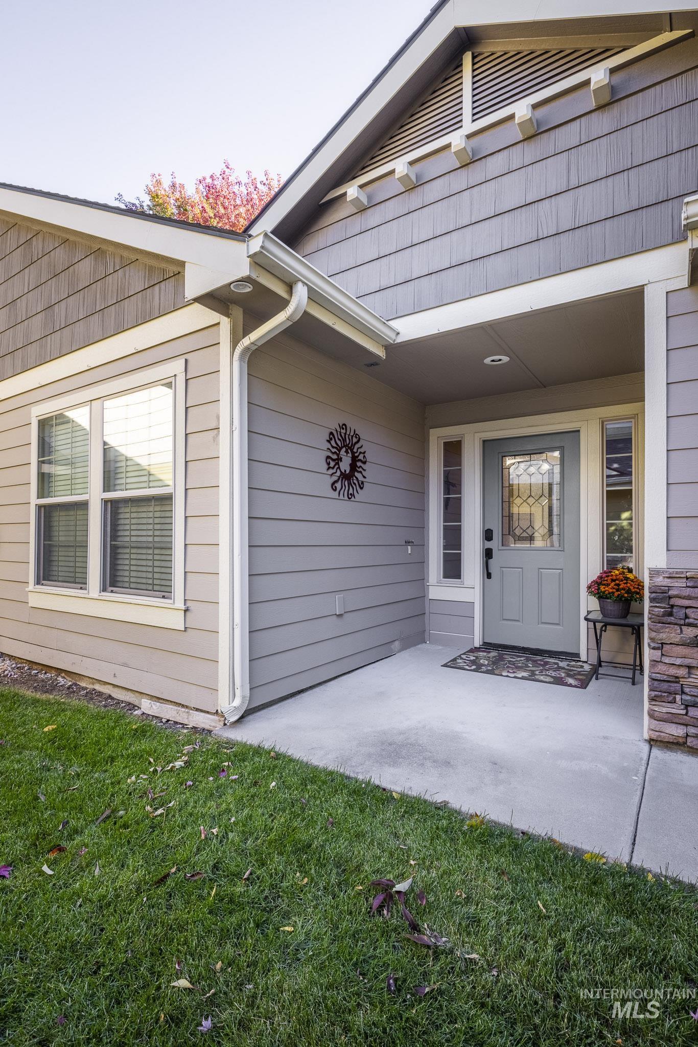 Entrance to property with a lawn