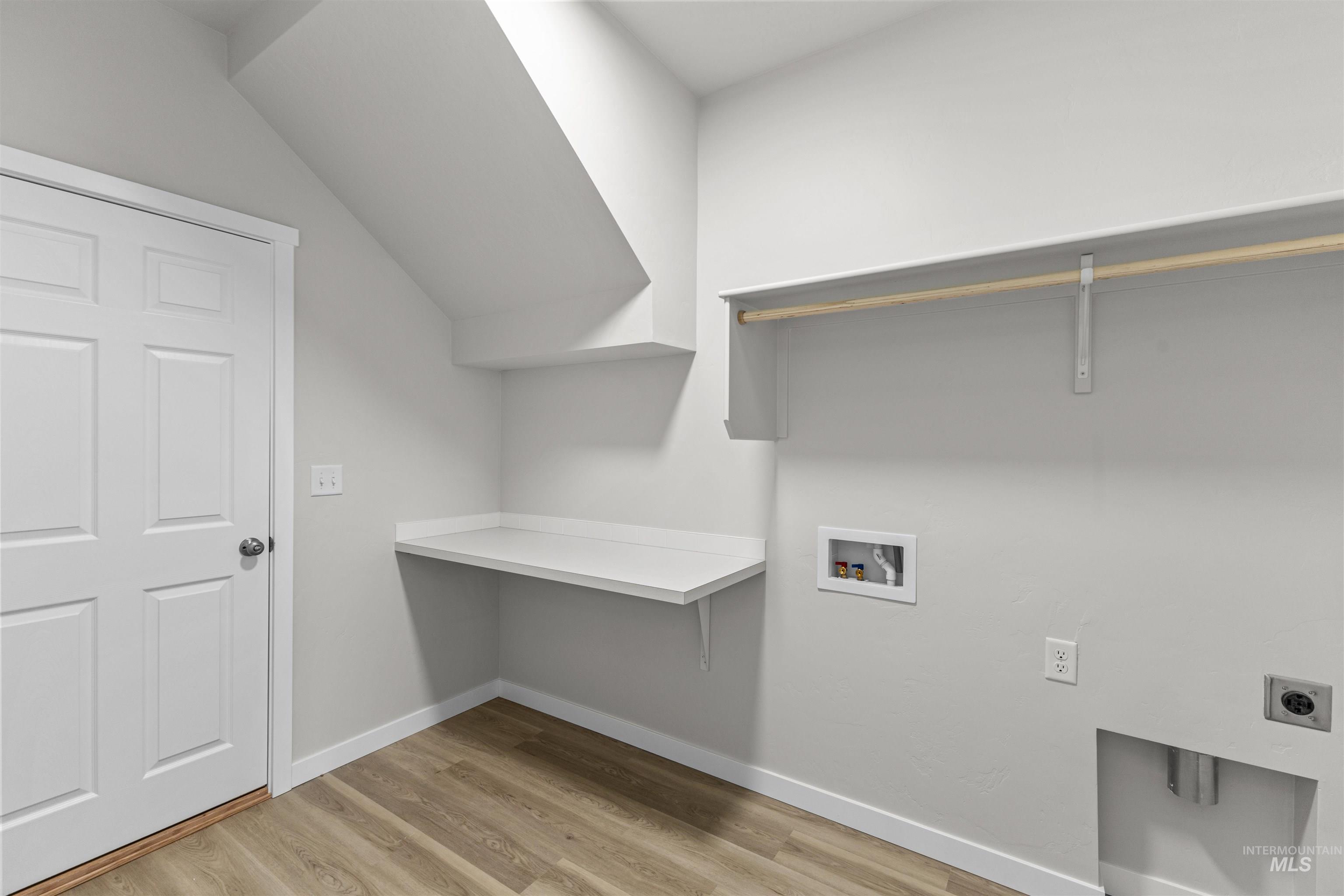 Washroom with washer hookup, light wood-type flooring, and electric dryer hookup