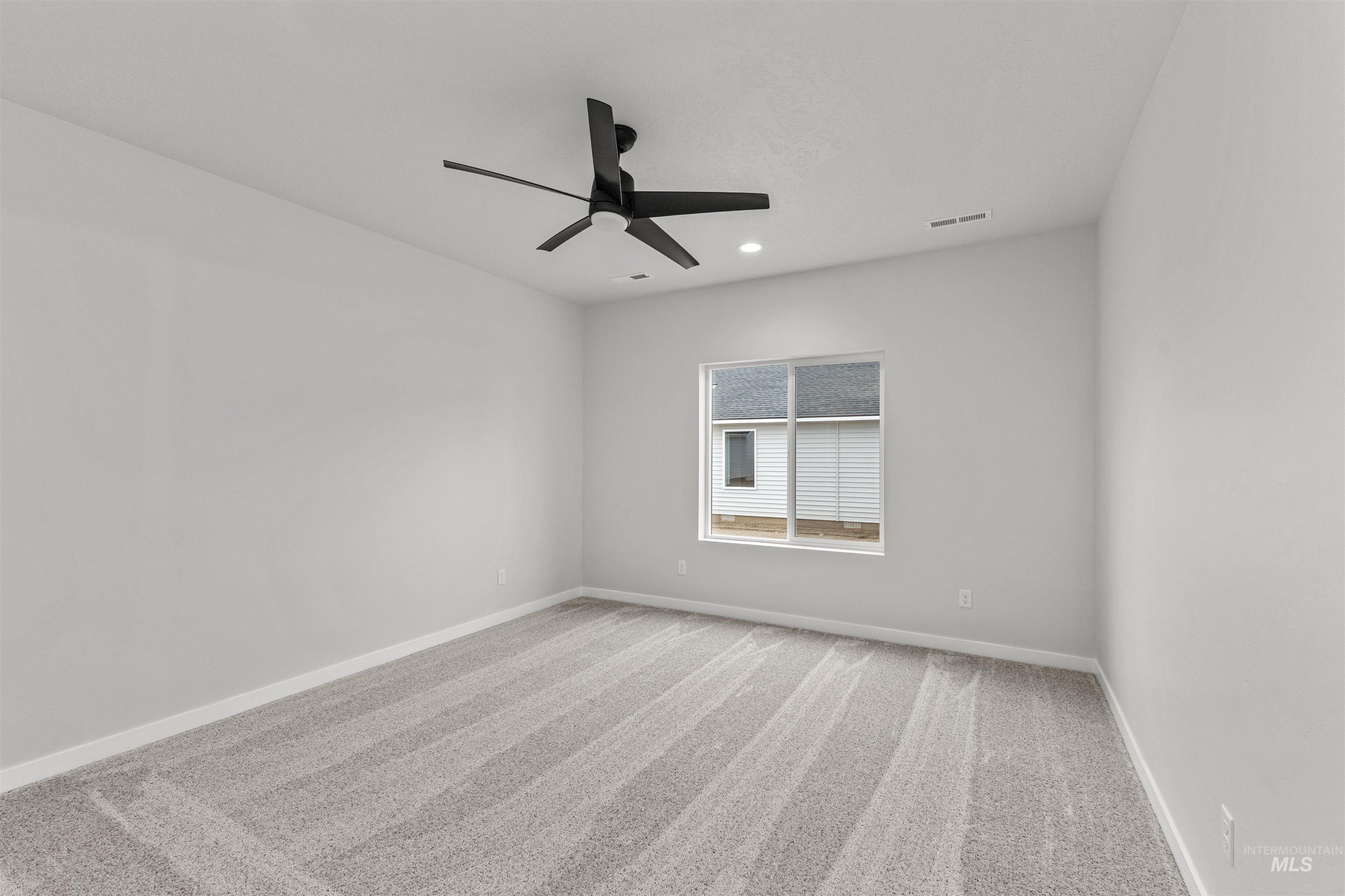 Empty room with light carpet, recessed lighting, and ceiling fan