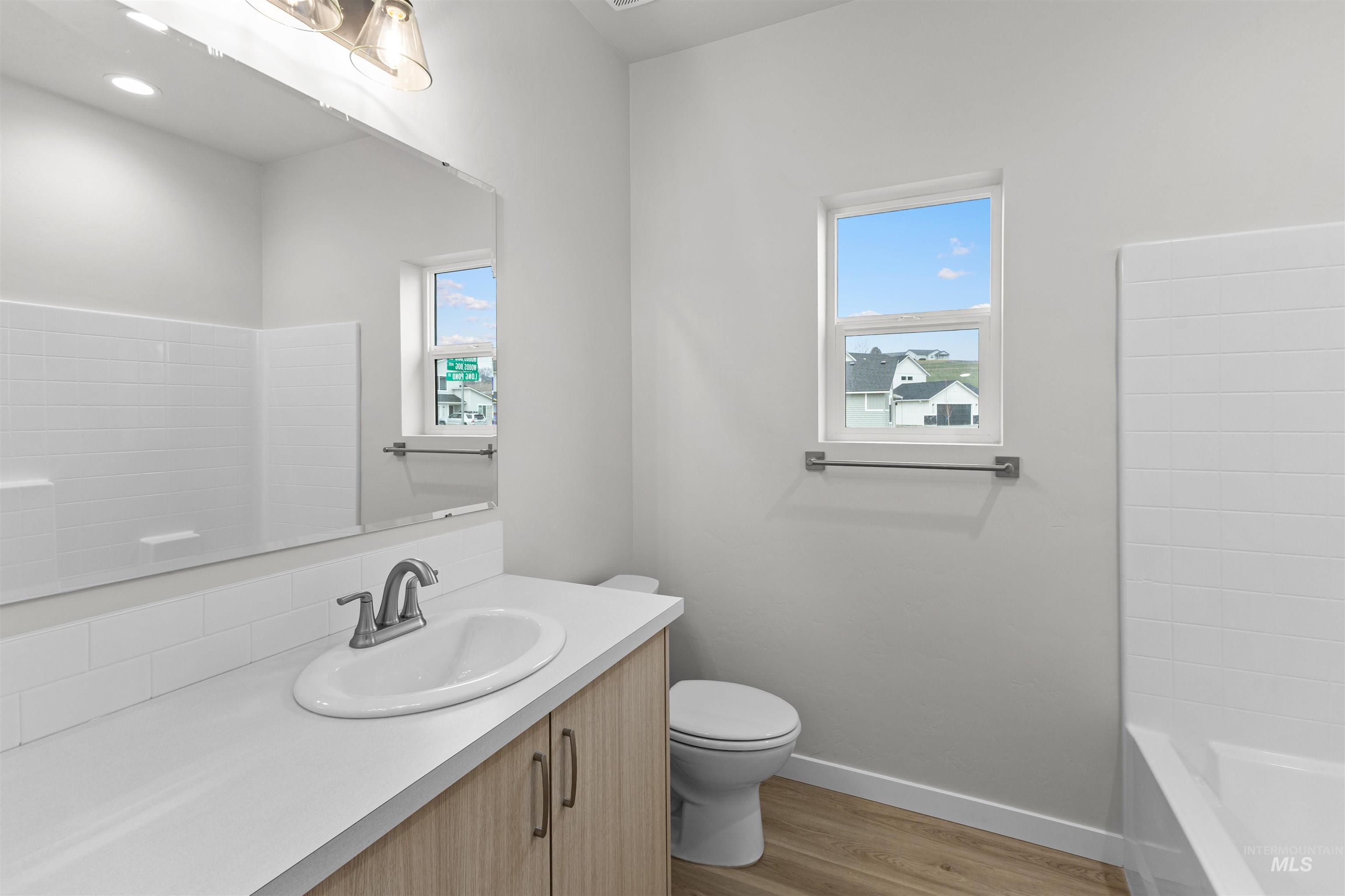 Bathroom featuring vanity, light wood finished floors, and shower / bath combination