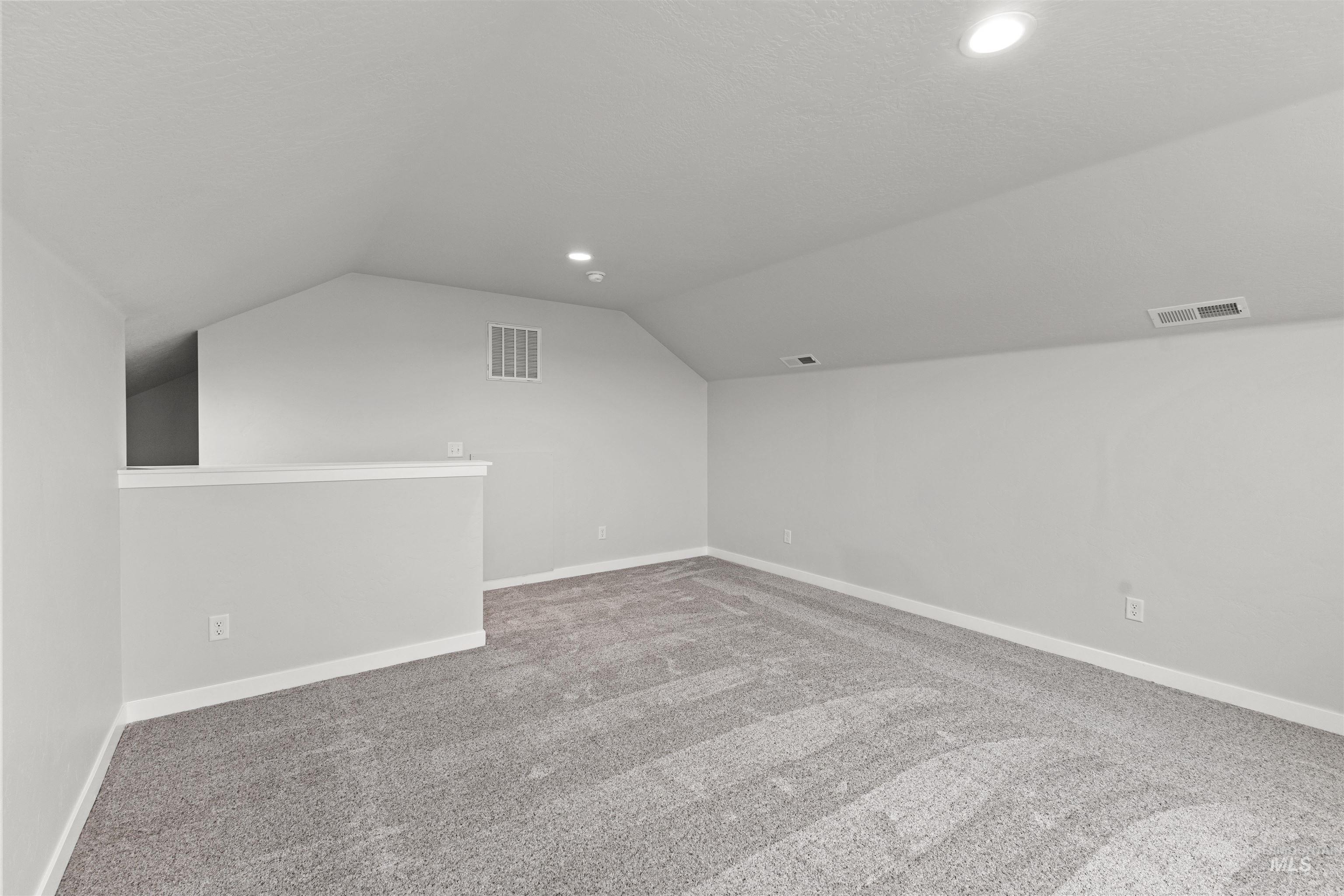Additional living space with lofted ceiling, carpet, and recessed lighting
