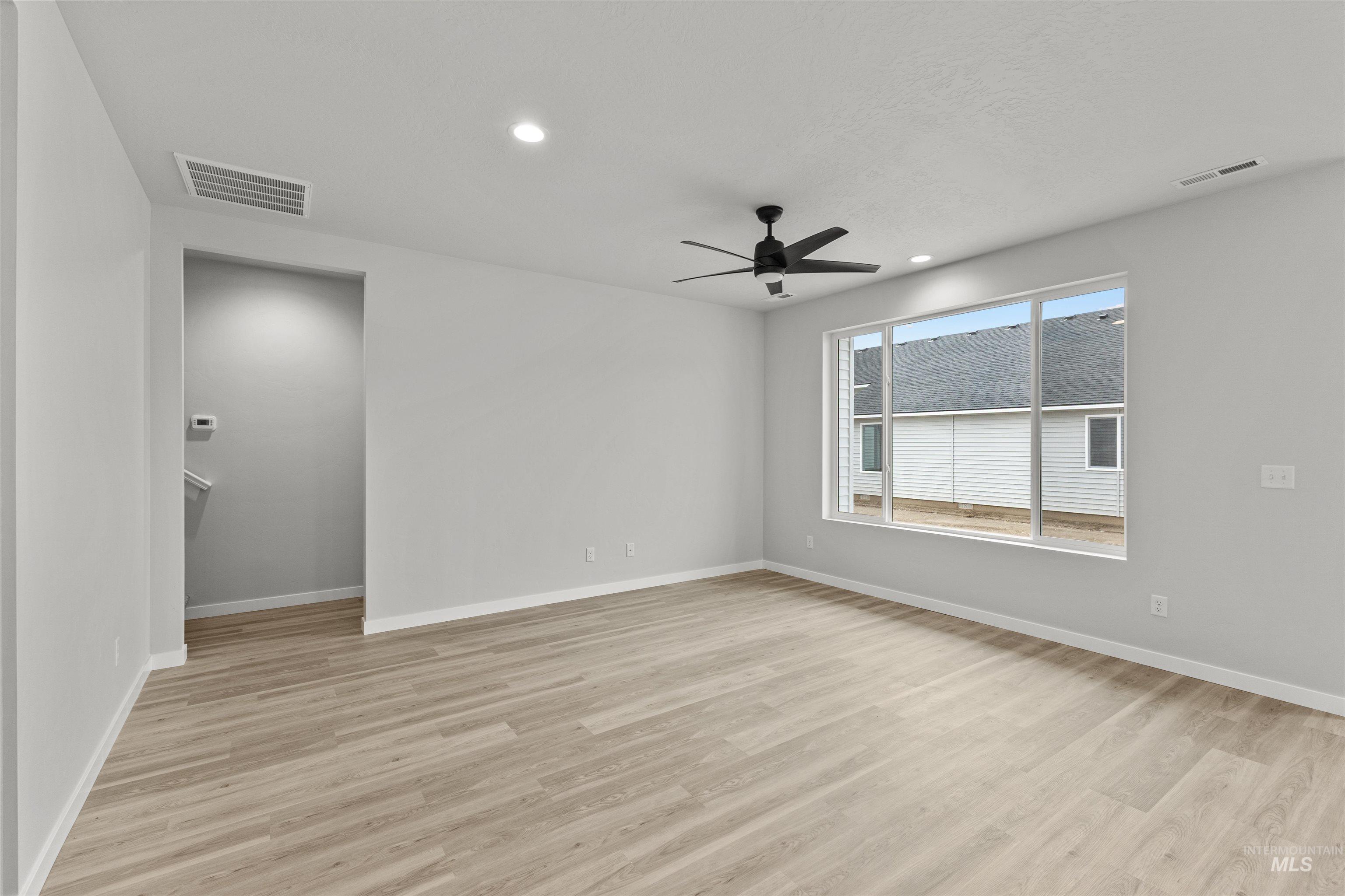 Empty room featuring recessed lighting, a ceiling fan, and light wood-style flooring