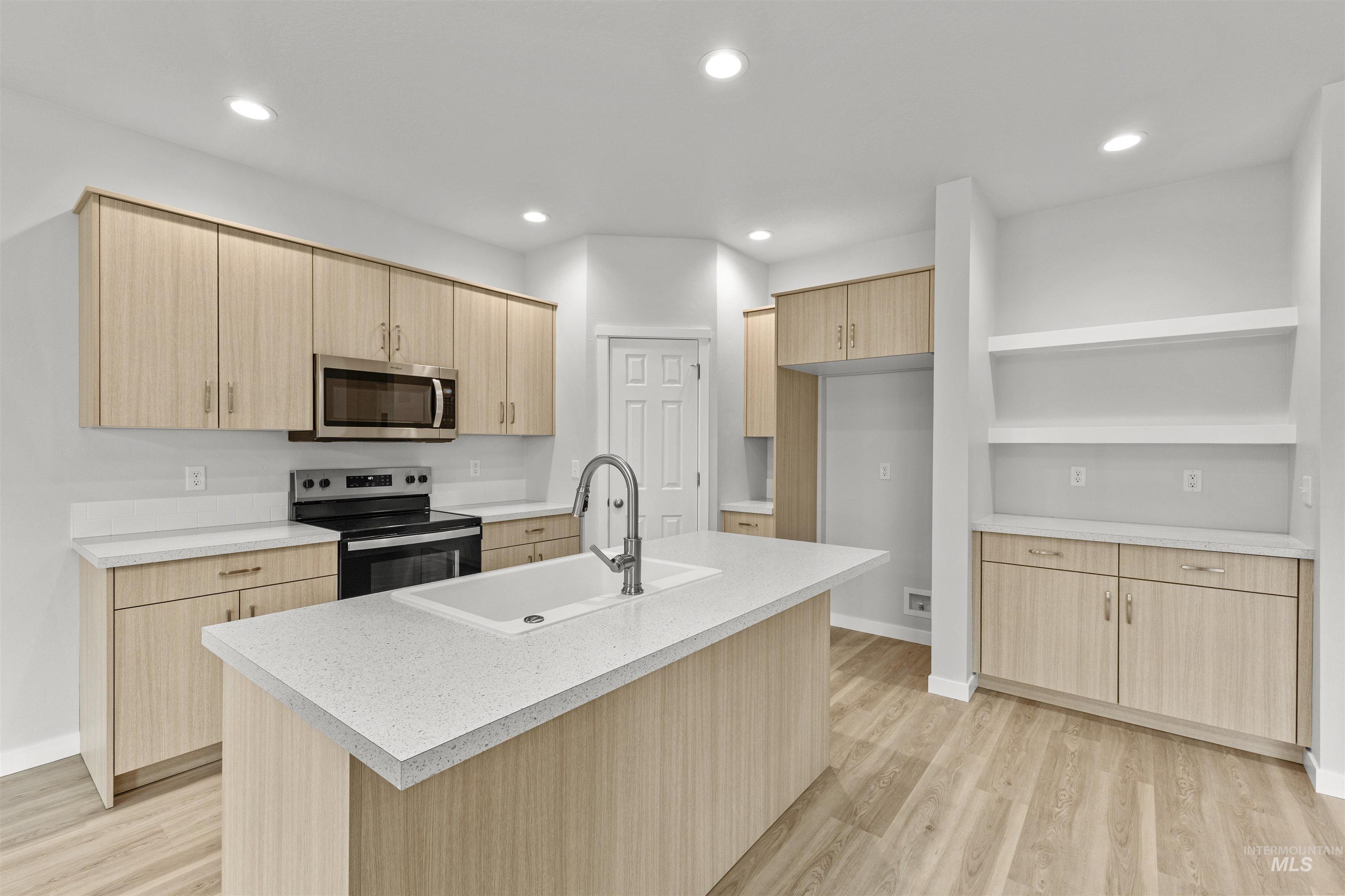 Kitchen featuring light brown cabinets, electric range, open shelves, stainless steel microwave, and recessed lighting