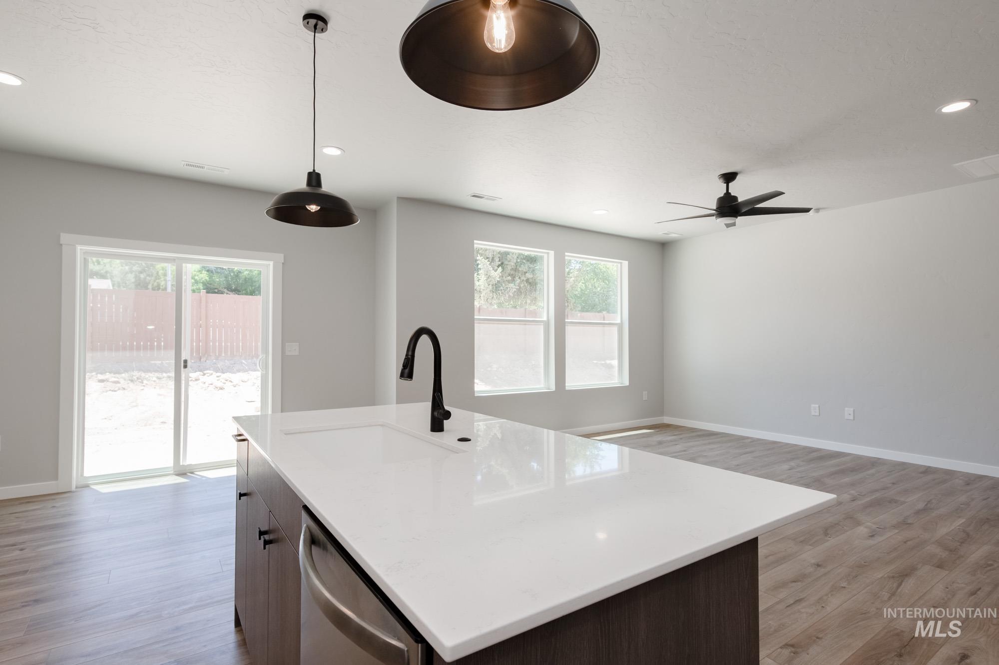 Kitchen featuring dishwasher, light wood-style flooring, plenty of natural light, a ceiling fan, and recessed lighting