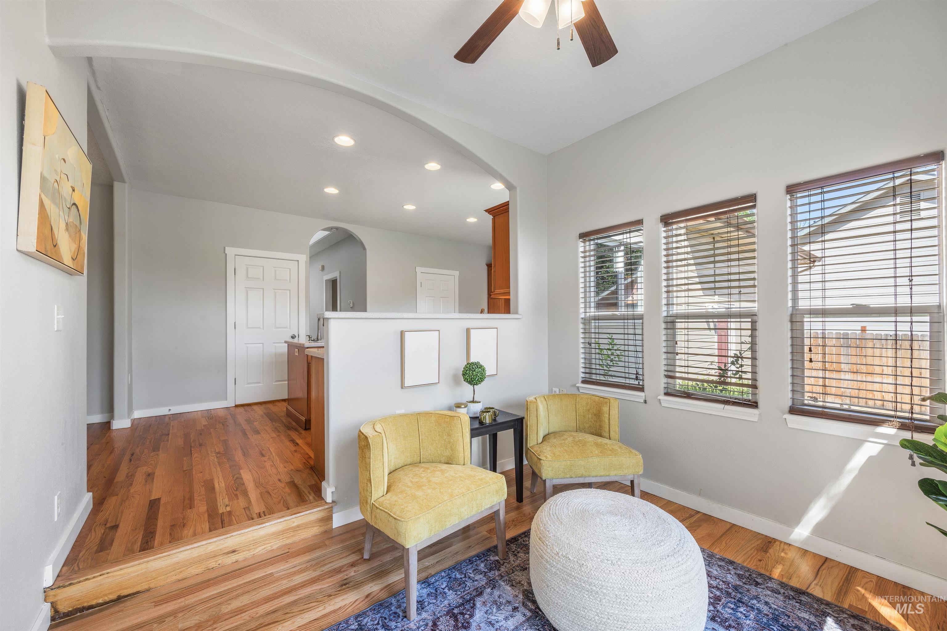 Sitting room featuring recessed lighting, light wood-style flooring, a ceiling fan, and arched walkways