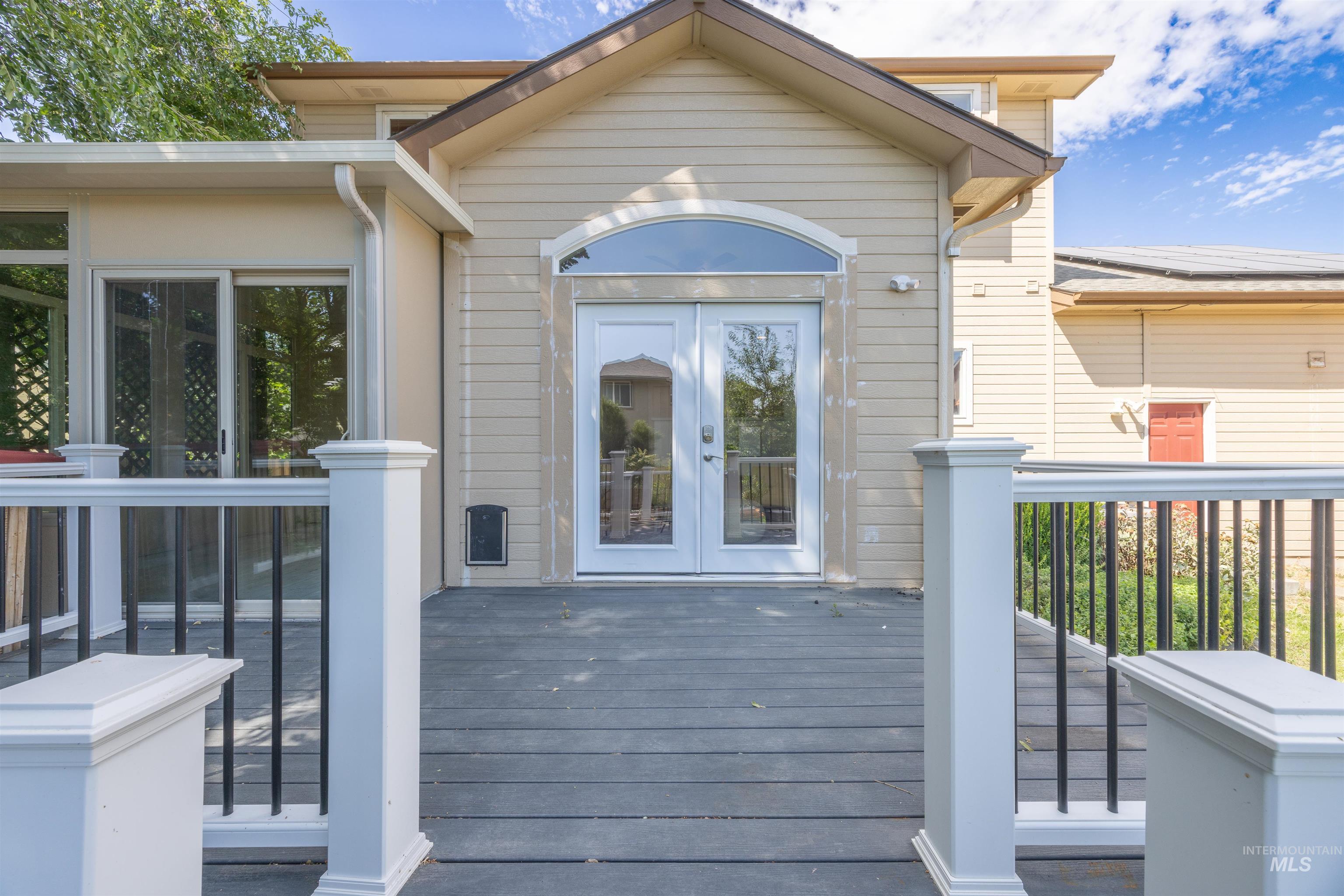 Doorway to property featuring a wooden deck and french doors