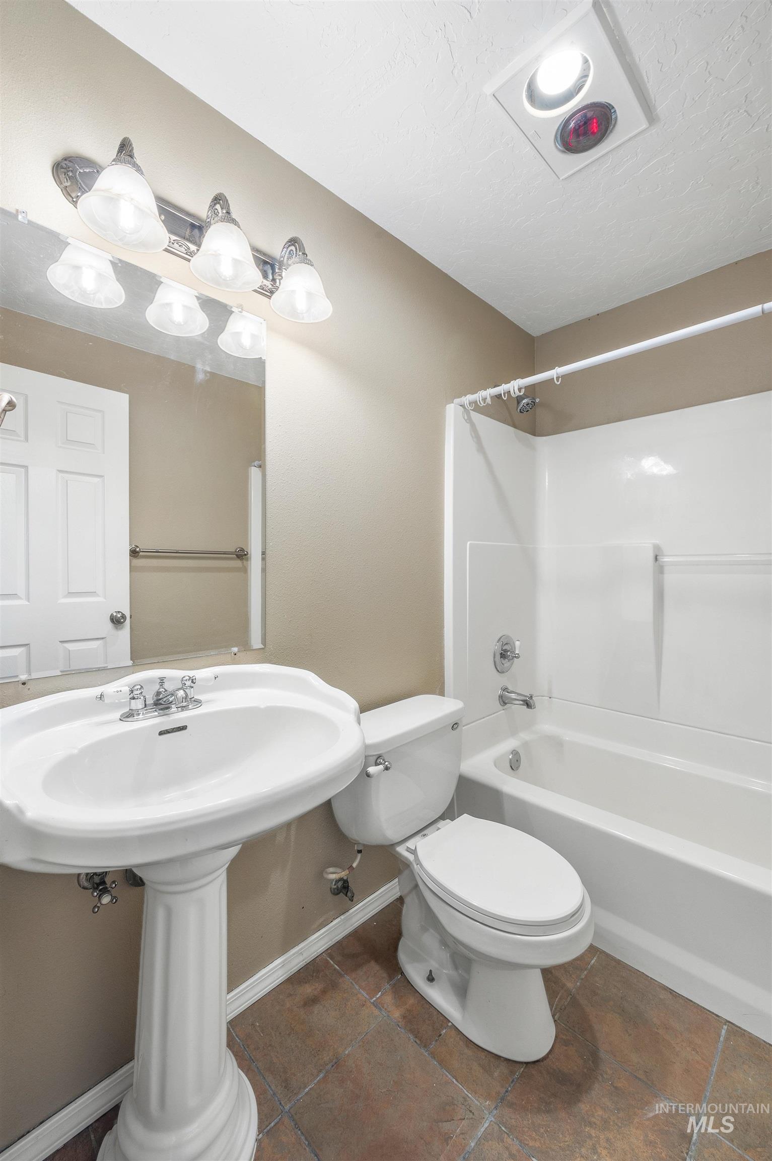 Bathroom featuring washtub / shower combination and a textured ceiling