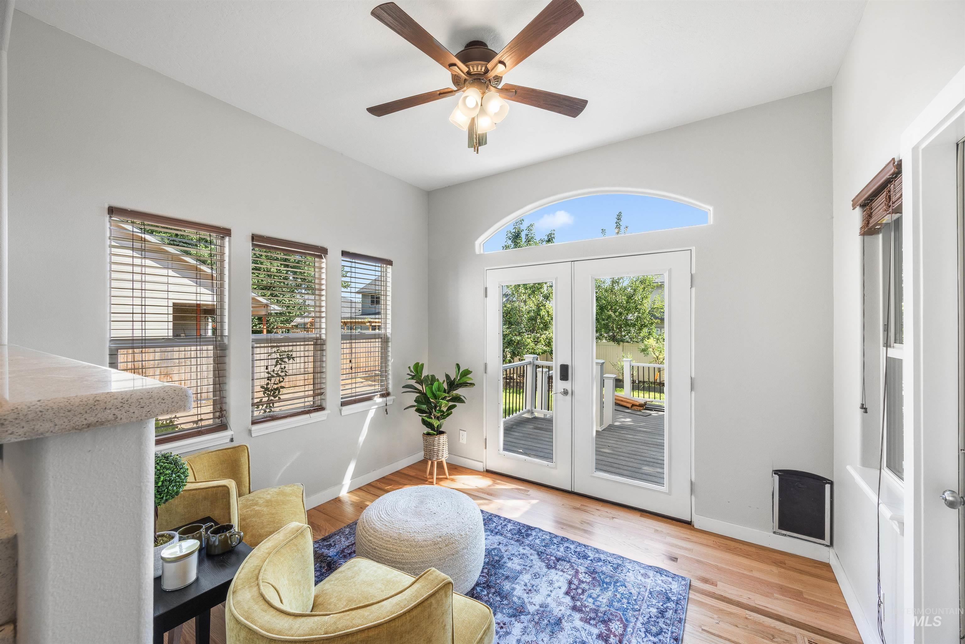 Doorway to outside with french doors, wood finished floors, and ceiling fan