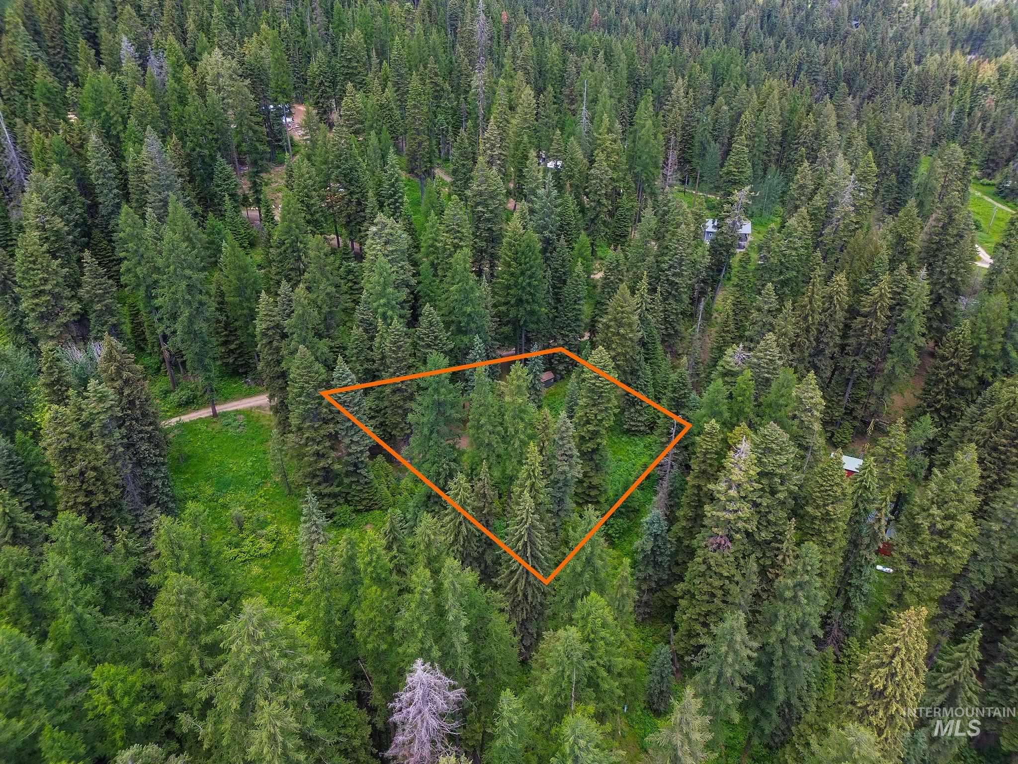 Aerial overview of property's location featuring a forest and property boundaries highlighted