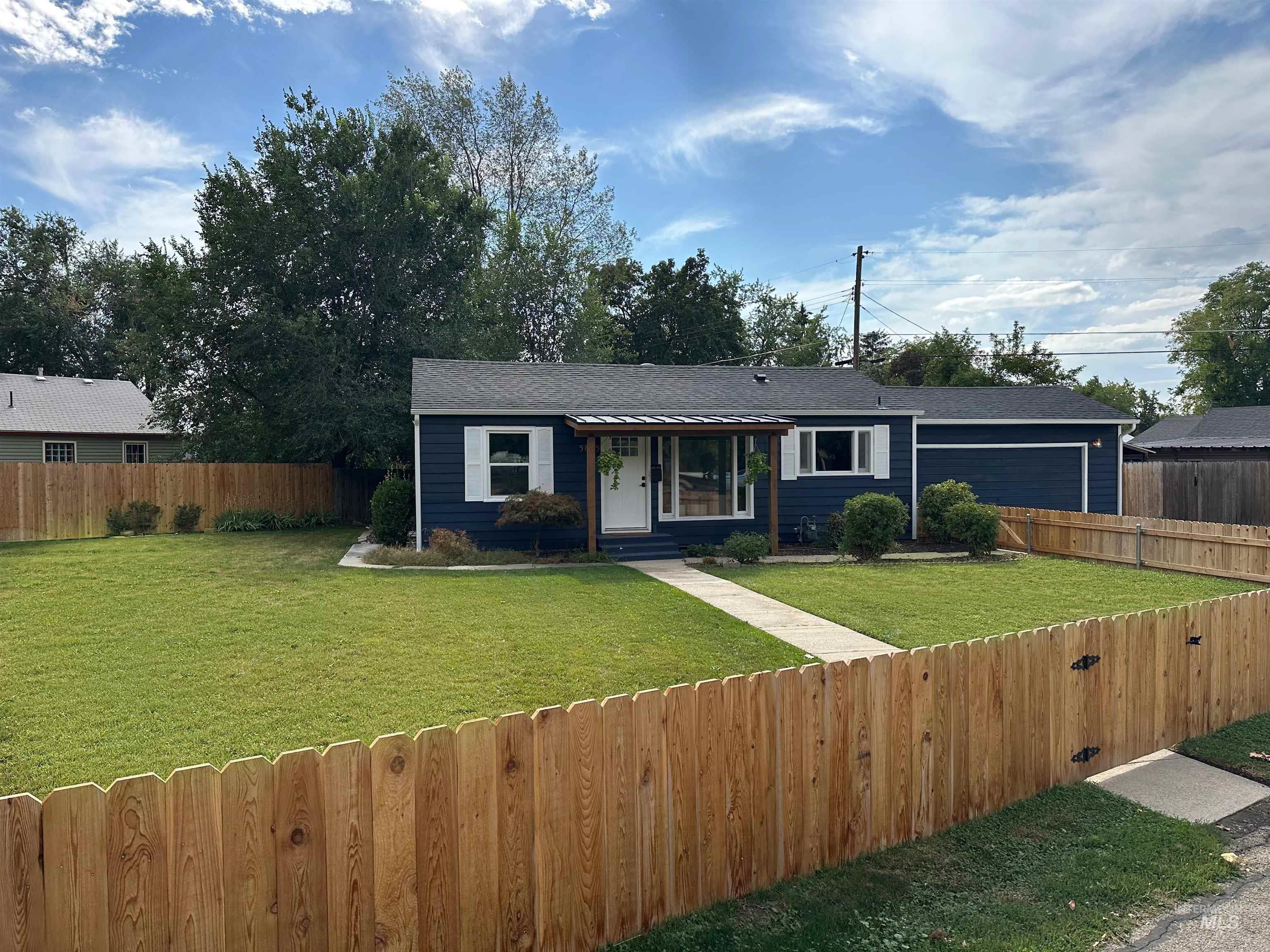 View of front of house featuring new cedar fence.
