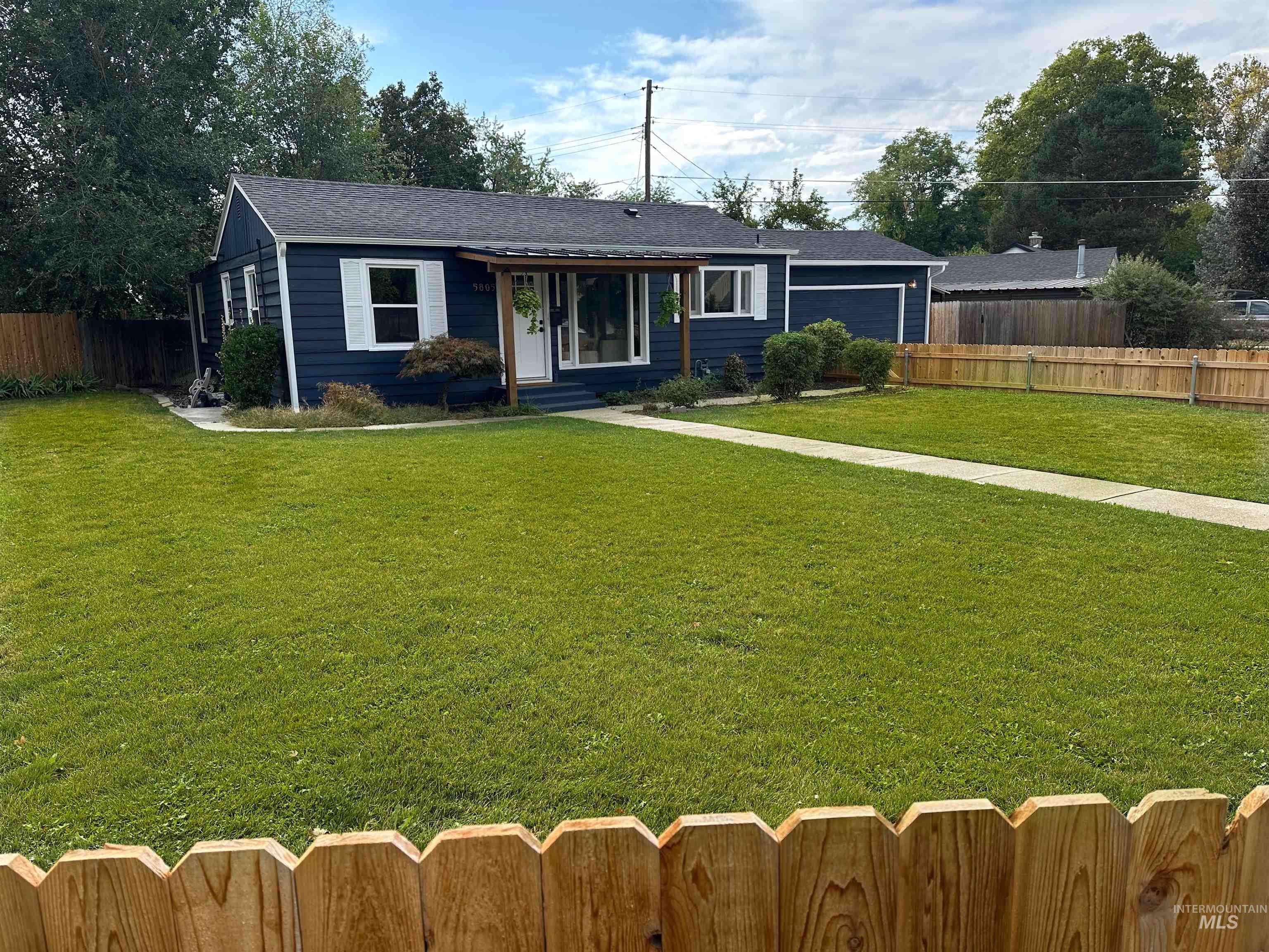 Front of house featuring the new cedar fence.