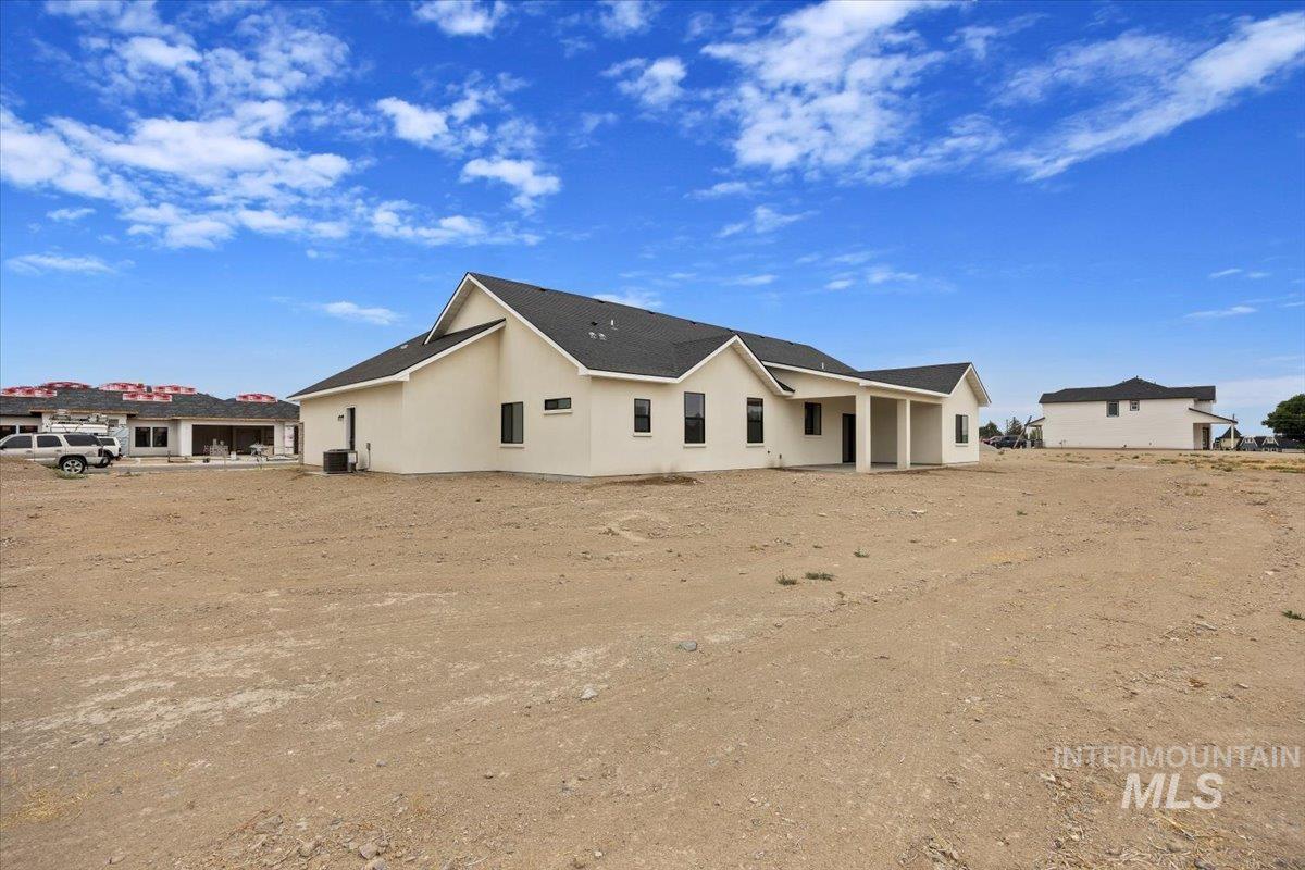 Back of property featuring a patio area and stucco siding