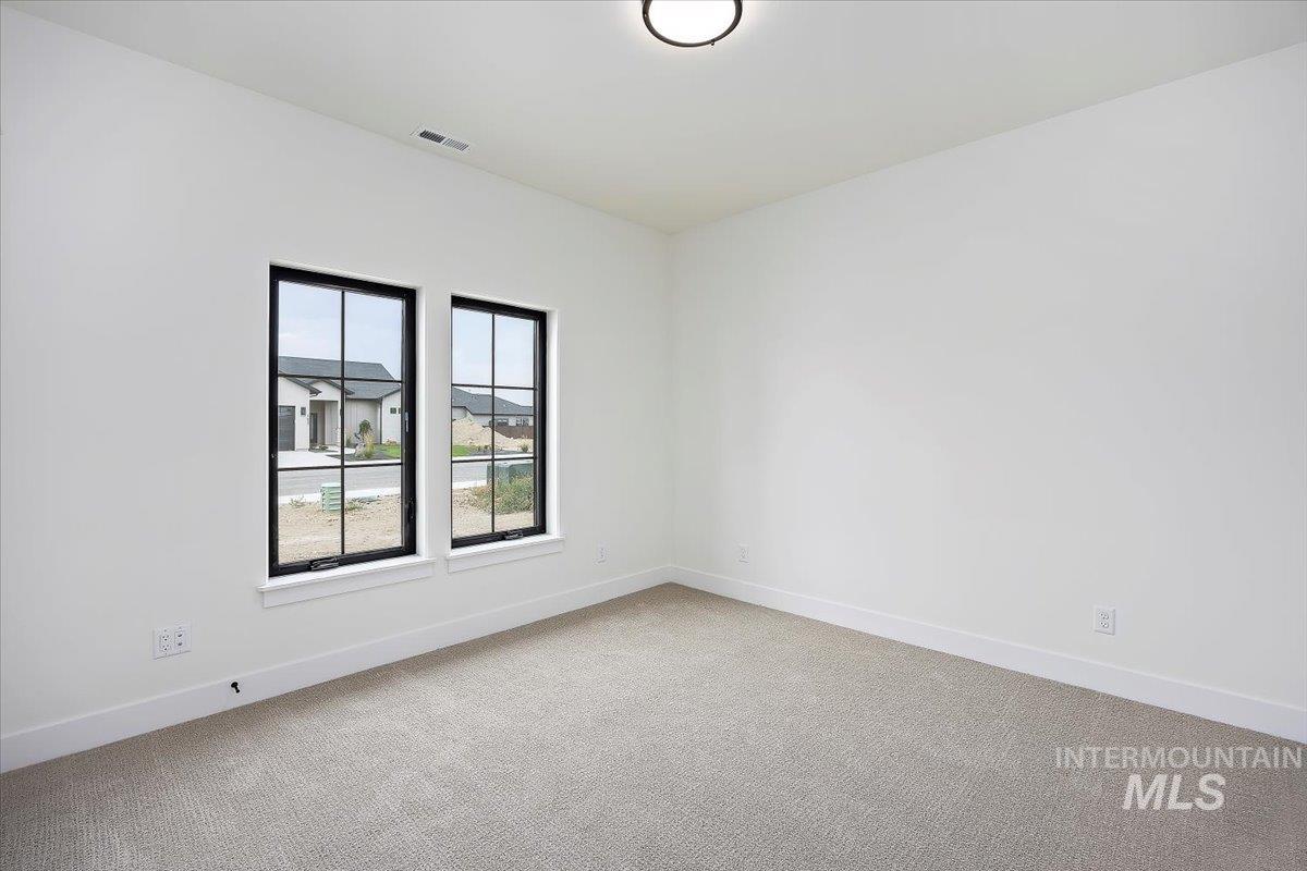 Spare room with carpet floors and baseboards