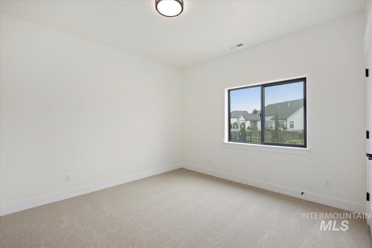 Spare room with light colored carpet