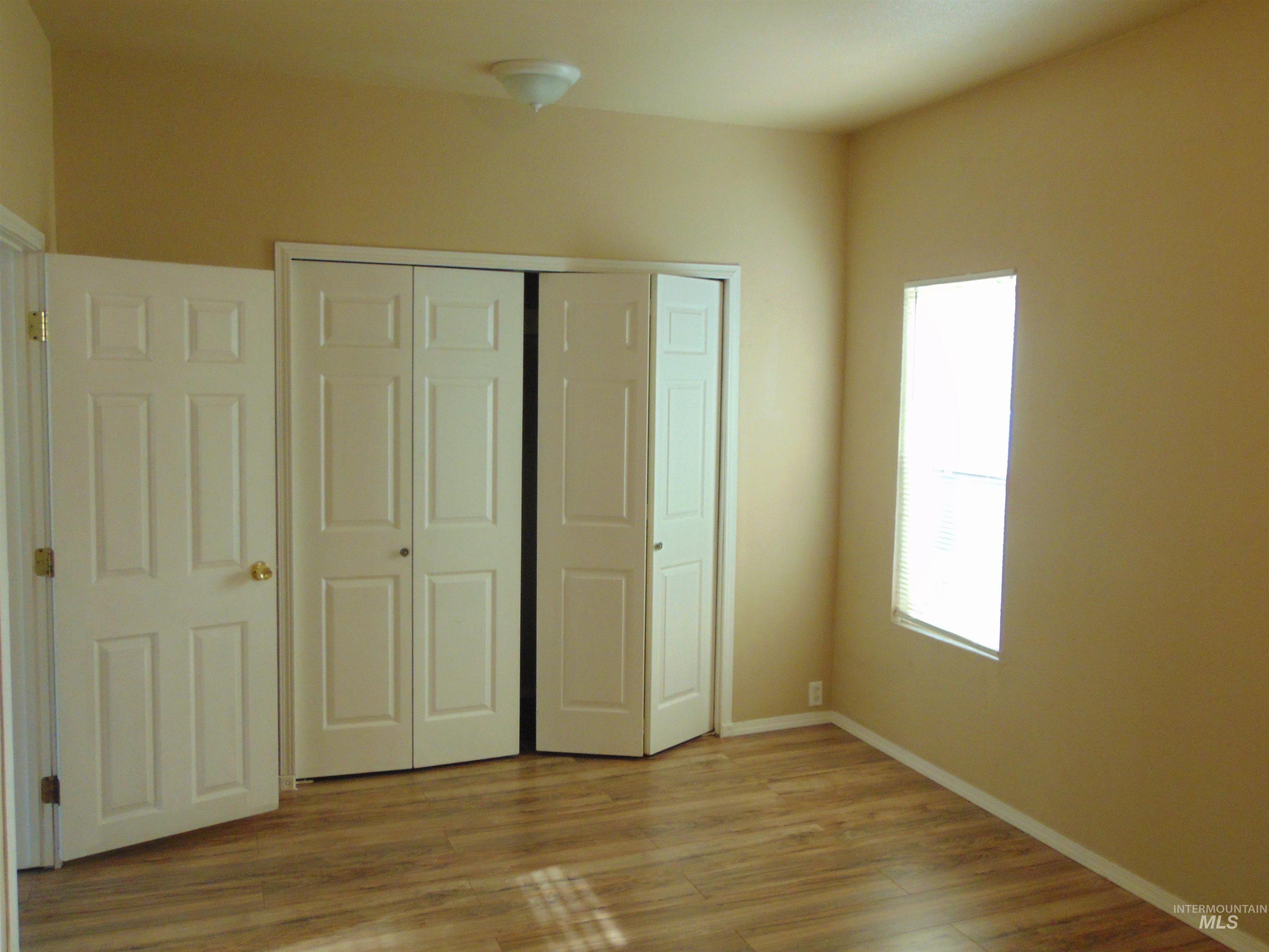 Unfurnished bedroom featuring a closet and light wood-style floors