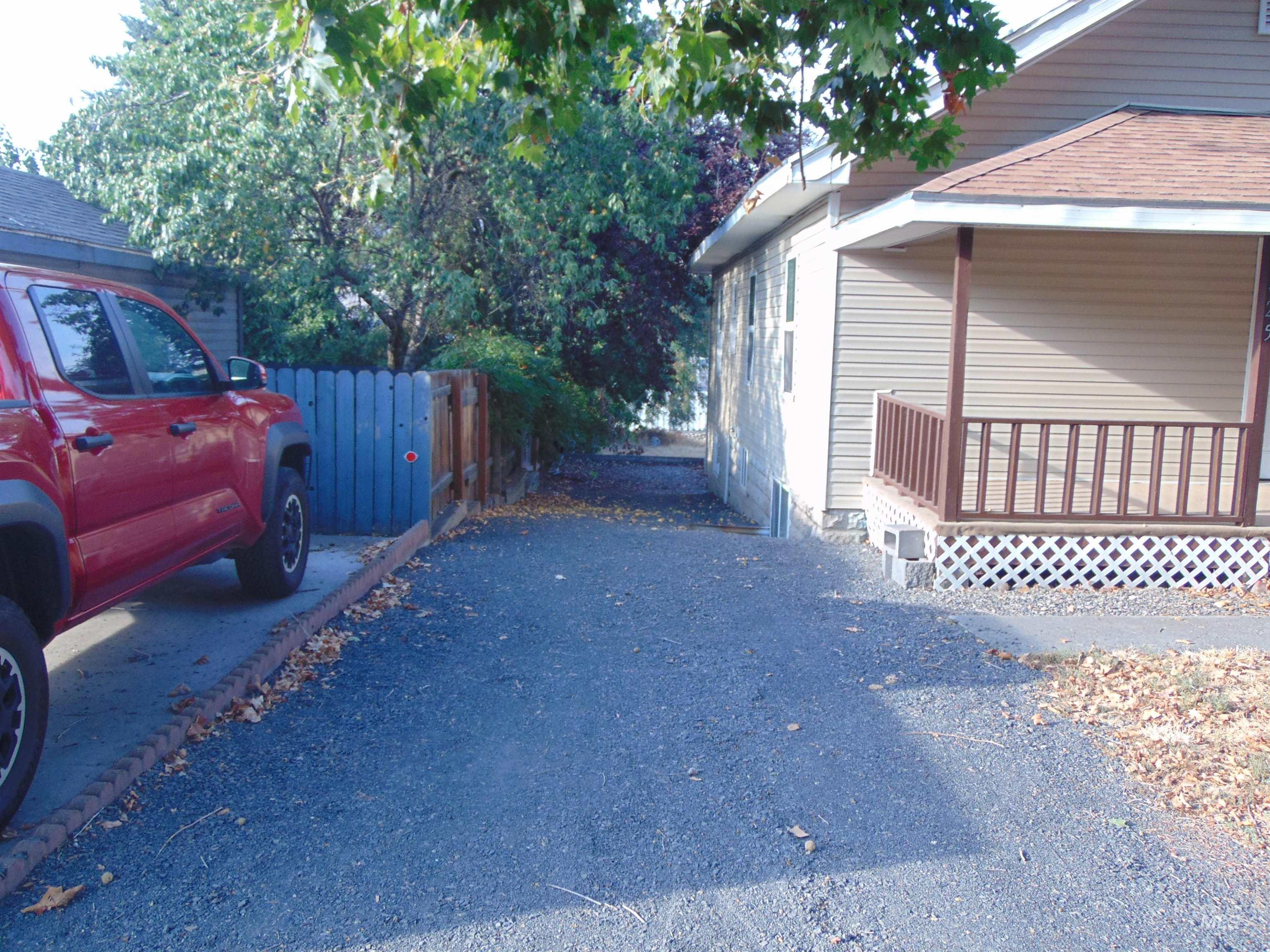 View of side of property featuring a wooden deck