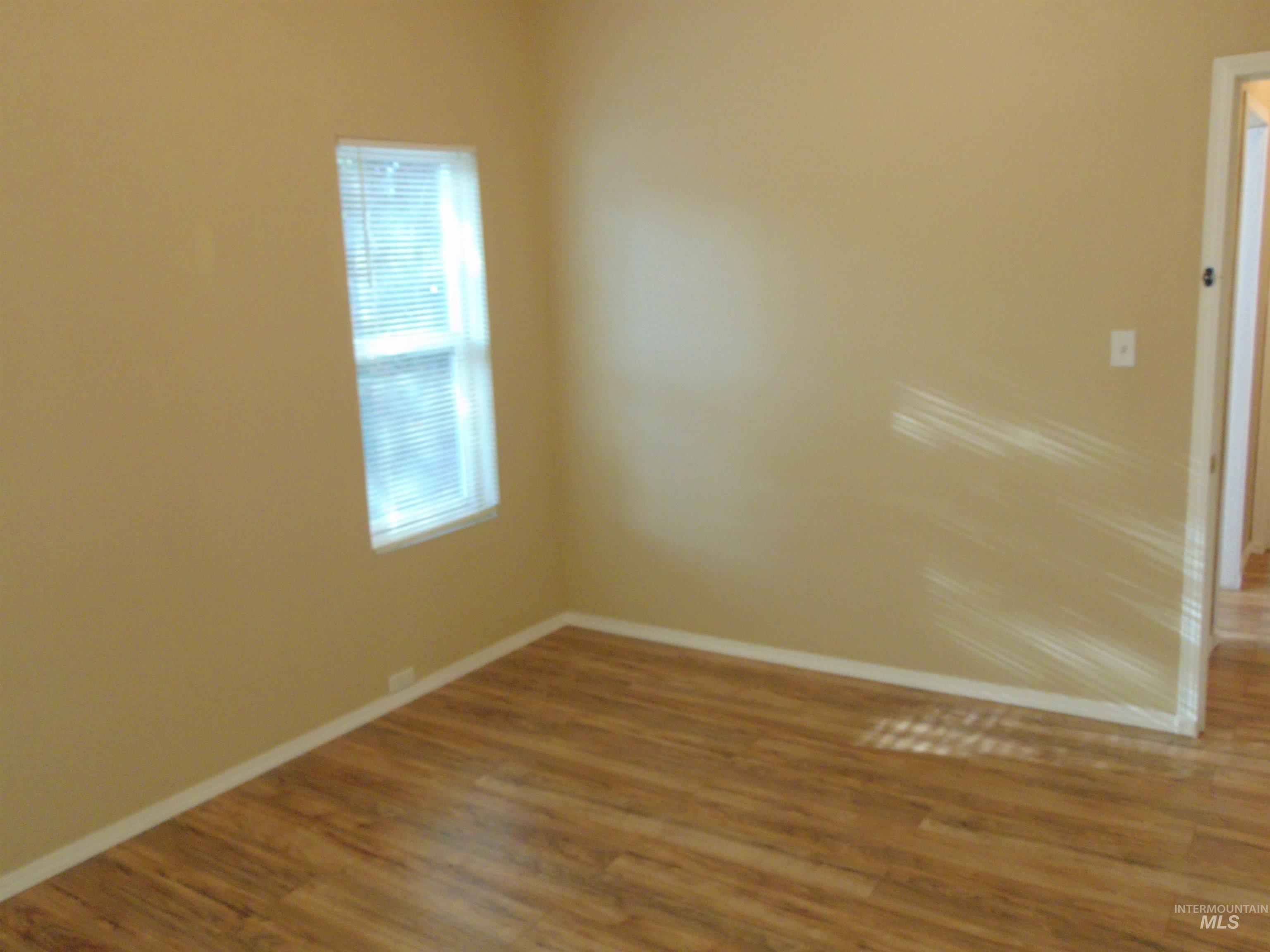 Unfurnished room featuring wood finished floors