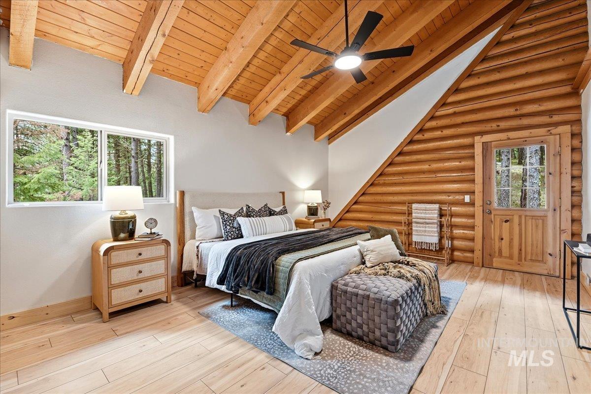 Vaulted wood-plank ceilings with exposed beams and a ceiling fan
