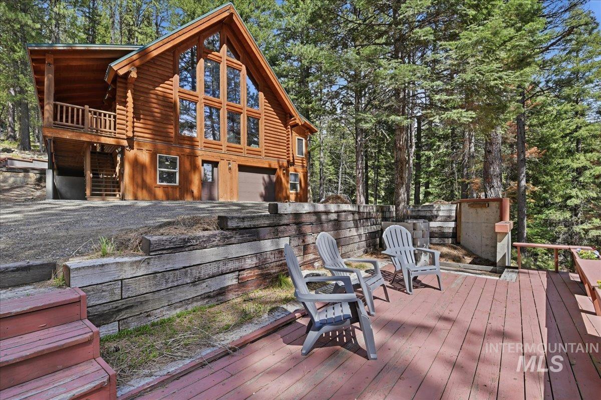 Log cabin-style residence featuring a prominent gabled roofline and extensive window arrangements