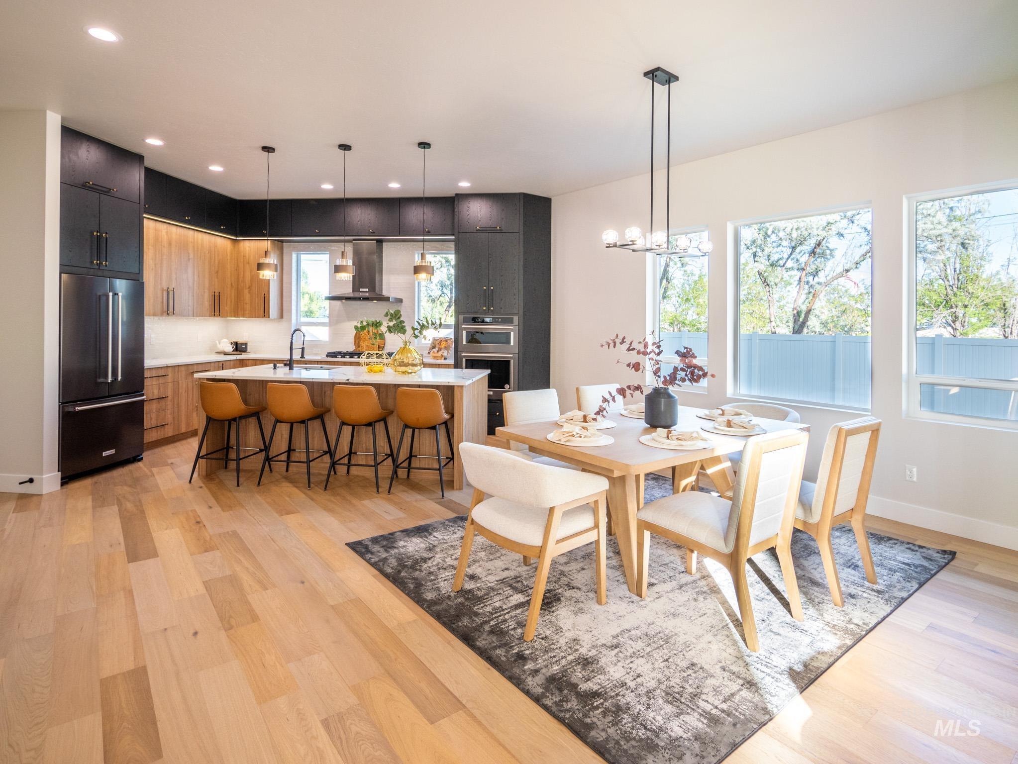 Dining room with light wood-type flooring, a chandelier, and recessed lighting